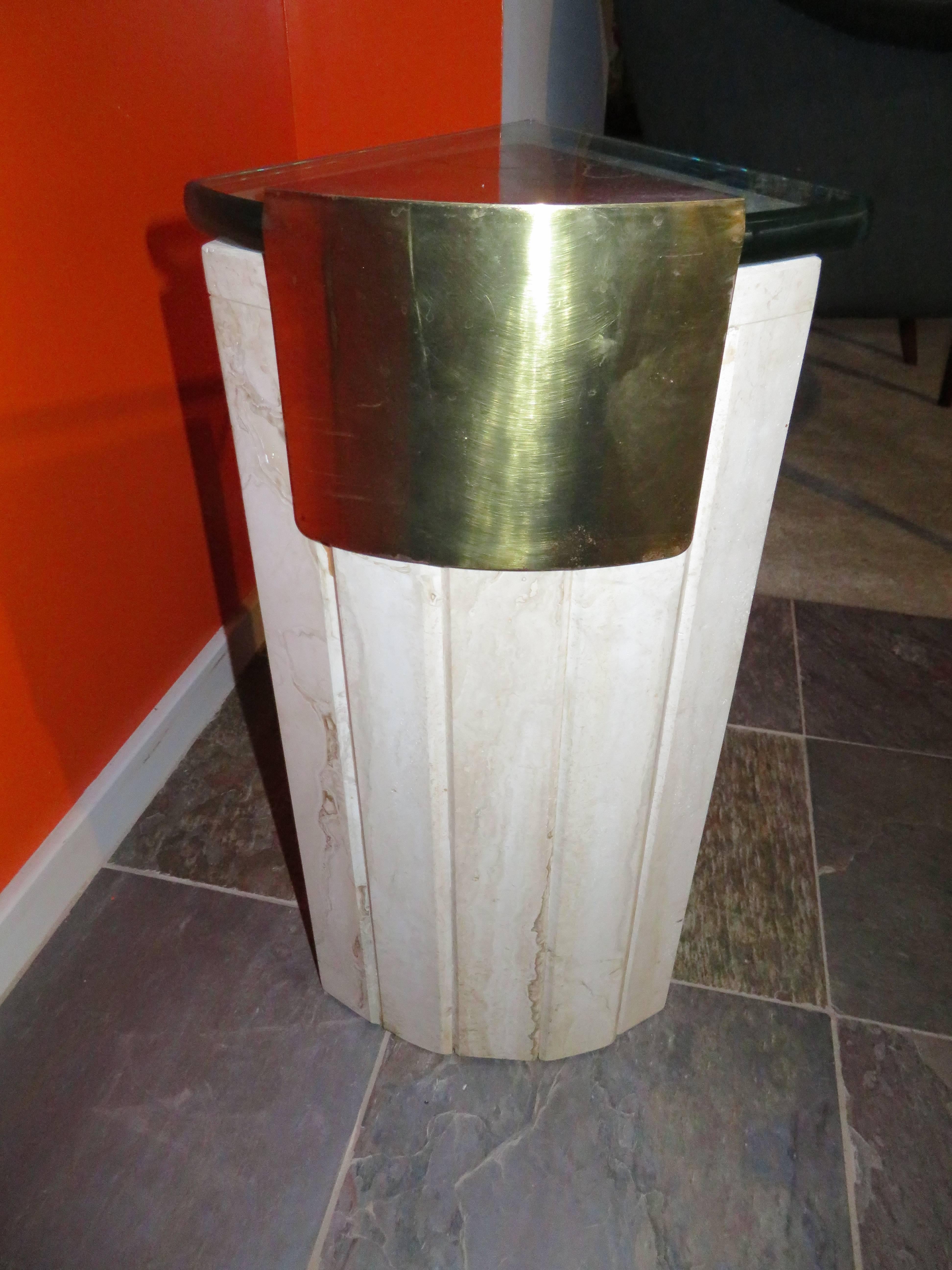 Excellent travertine, brass and glass wedge shaped side table. This wonderful side table is made of super heavy travertine marble with solid brass details and a triangular 3/4