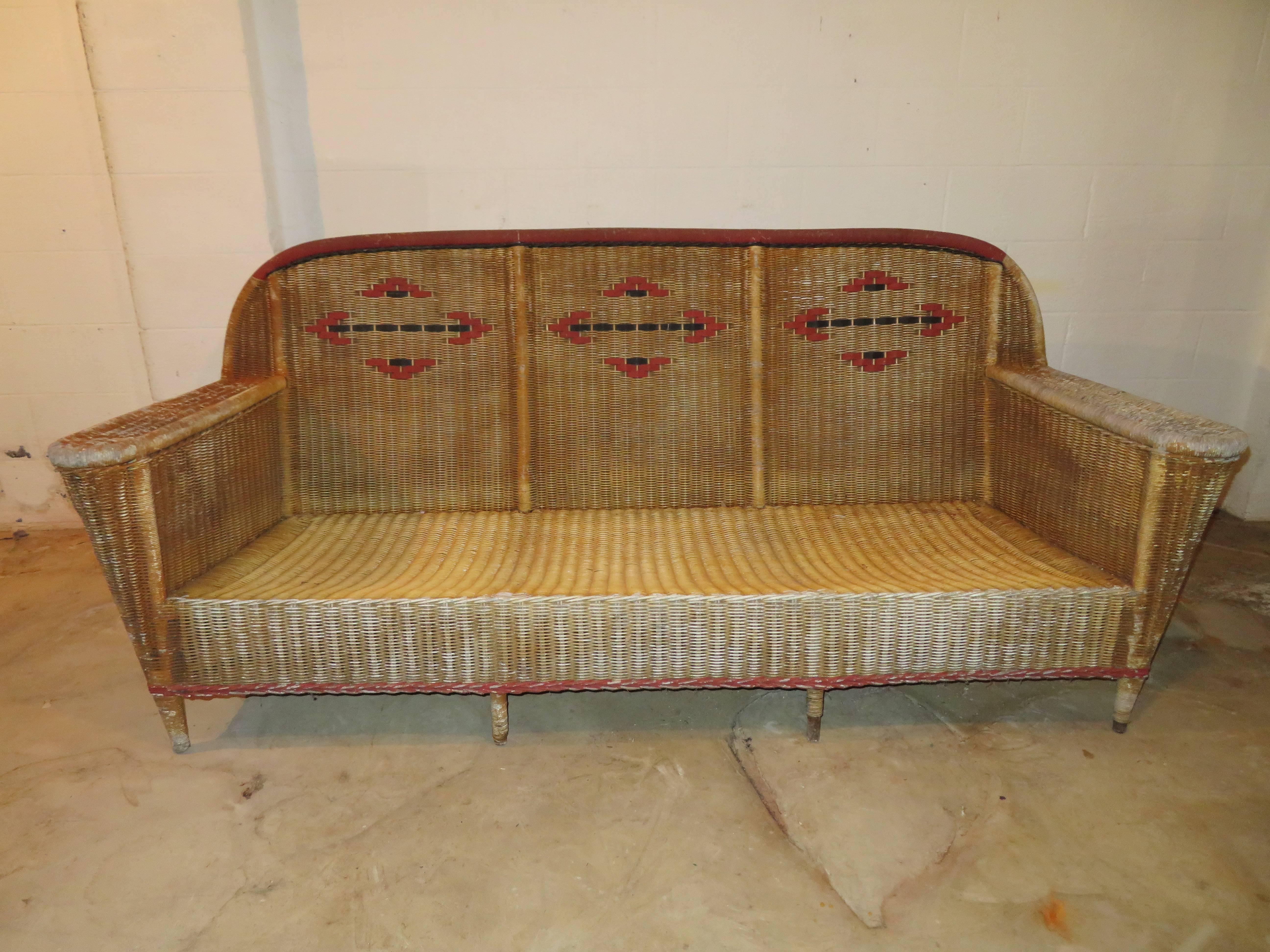 Fabulous and rare Art Deco seven-piece wicker set from the late 1940s. This set will need a new paint job and new cushions but the wicker is in very nice vintage condition with only a few strands of missing wrap on some legs. Set includes two lounge