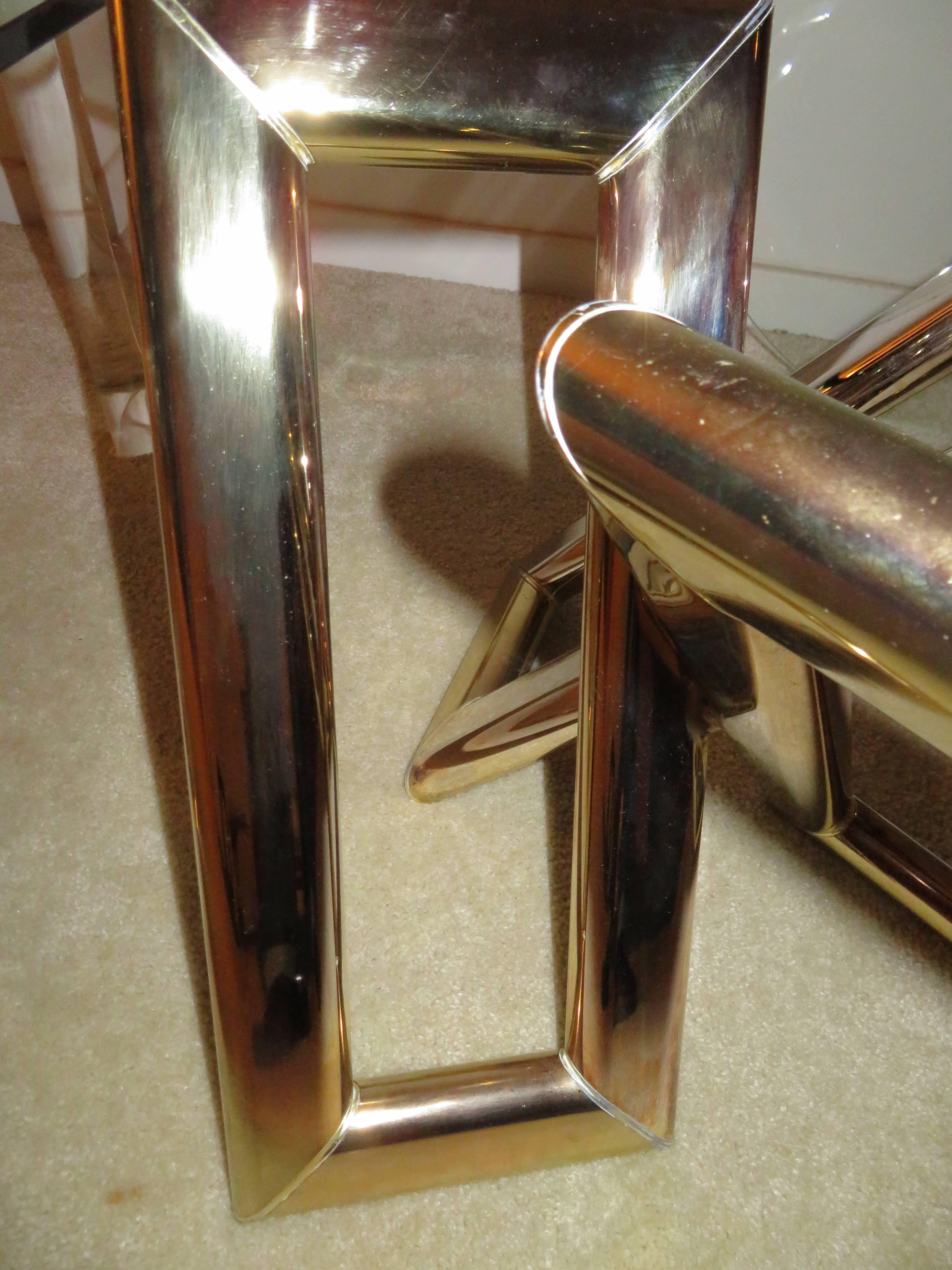 Interesting pair of geometric modern brass side tables.  3 chunky brass rectangular shaped pieces form these unusual side tables giving them an ultra modern feel.  The glass tops are new and can be custom sized but the tops on them are 30"