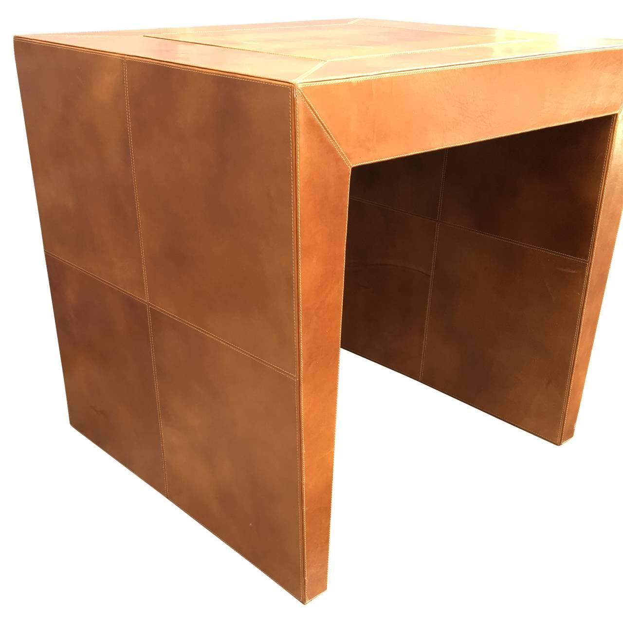 Small leather table that is originally a game table with a flip-top for chess and backgammon.