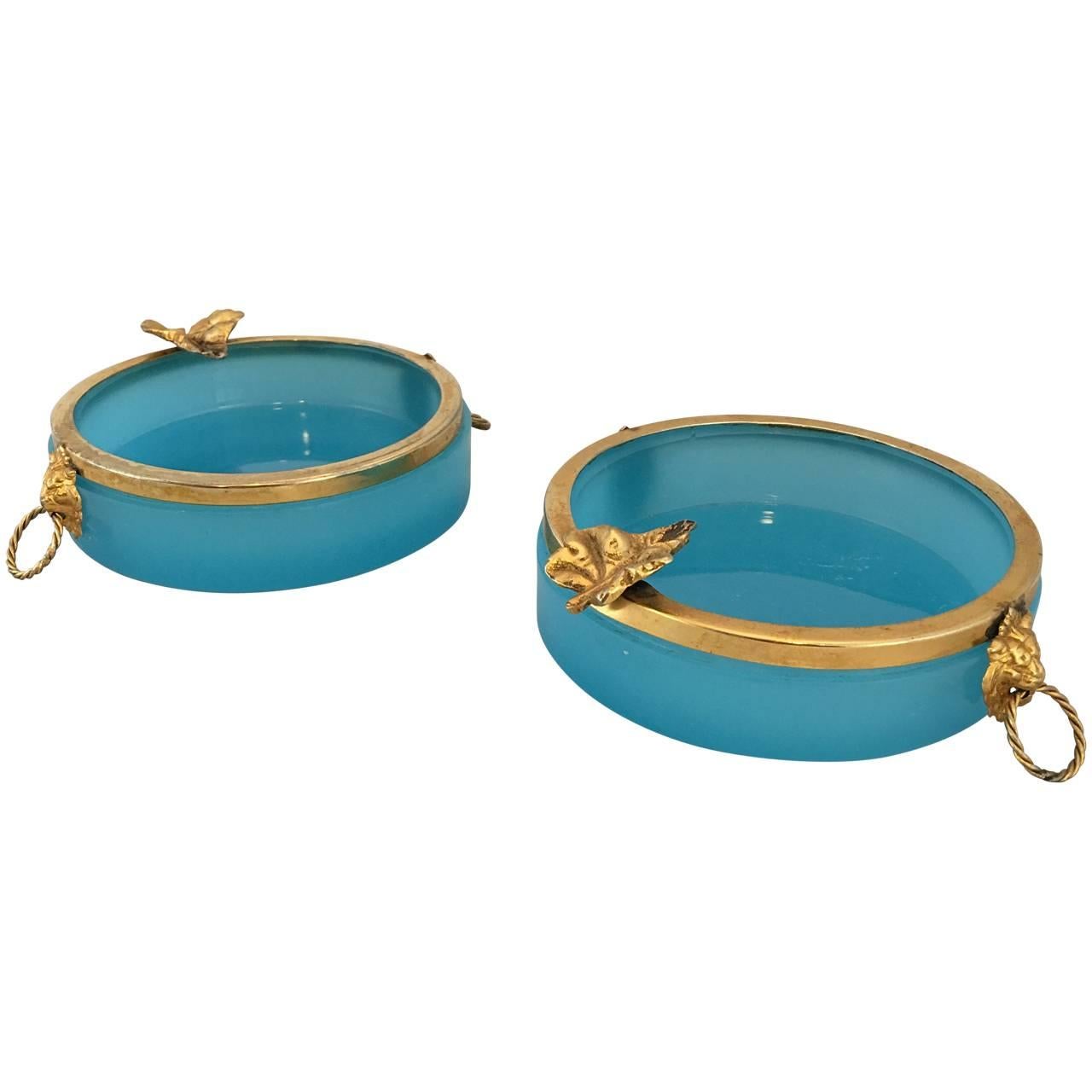 Two blue opaline ash trays with brass edging, lion heads and leaf shelf