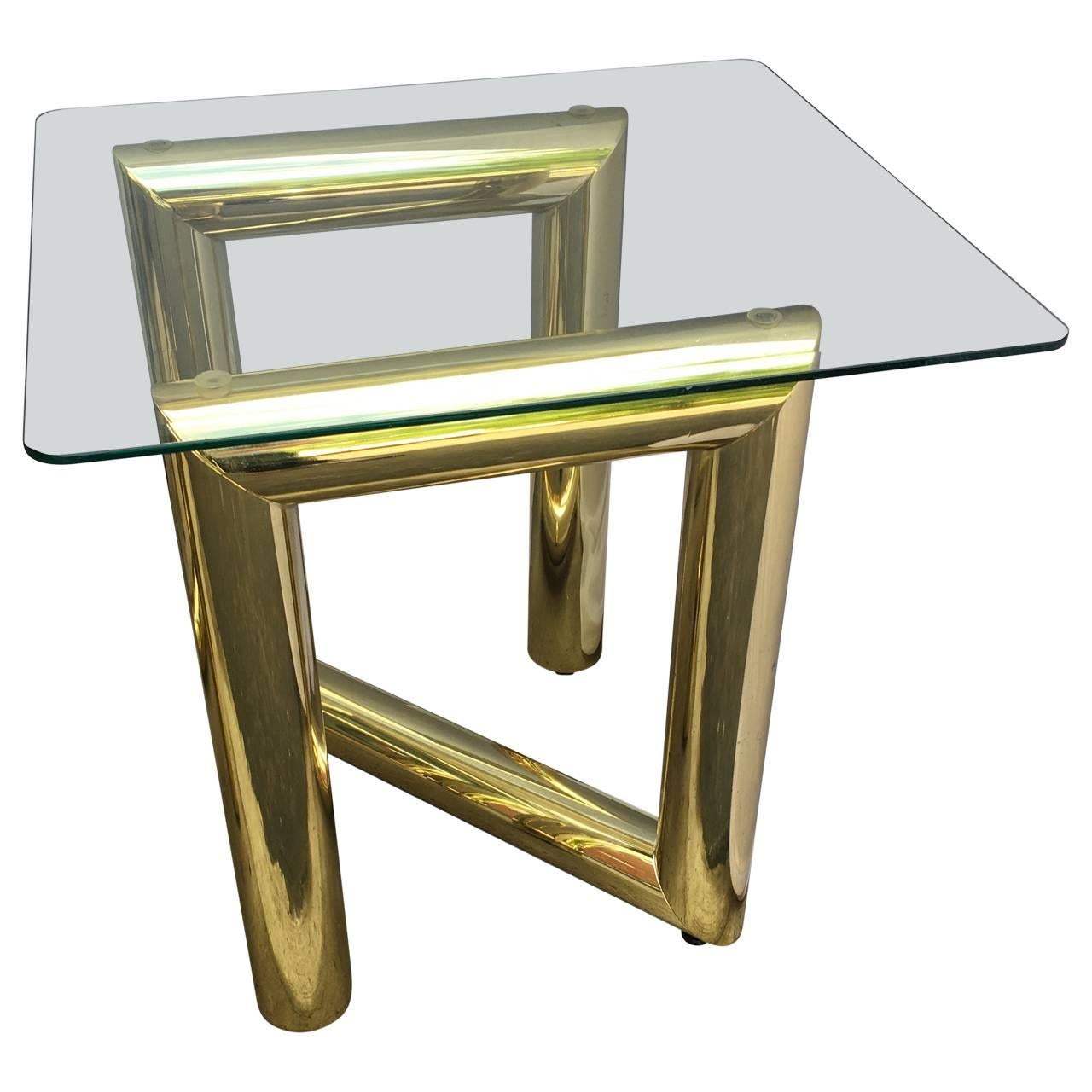 Two tubular brass-lacquered and glass-top side tables.
