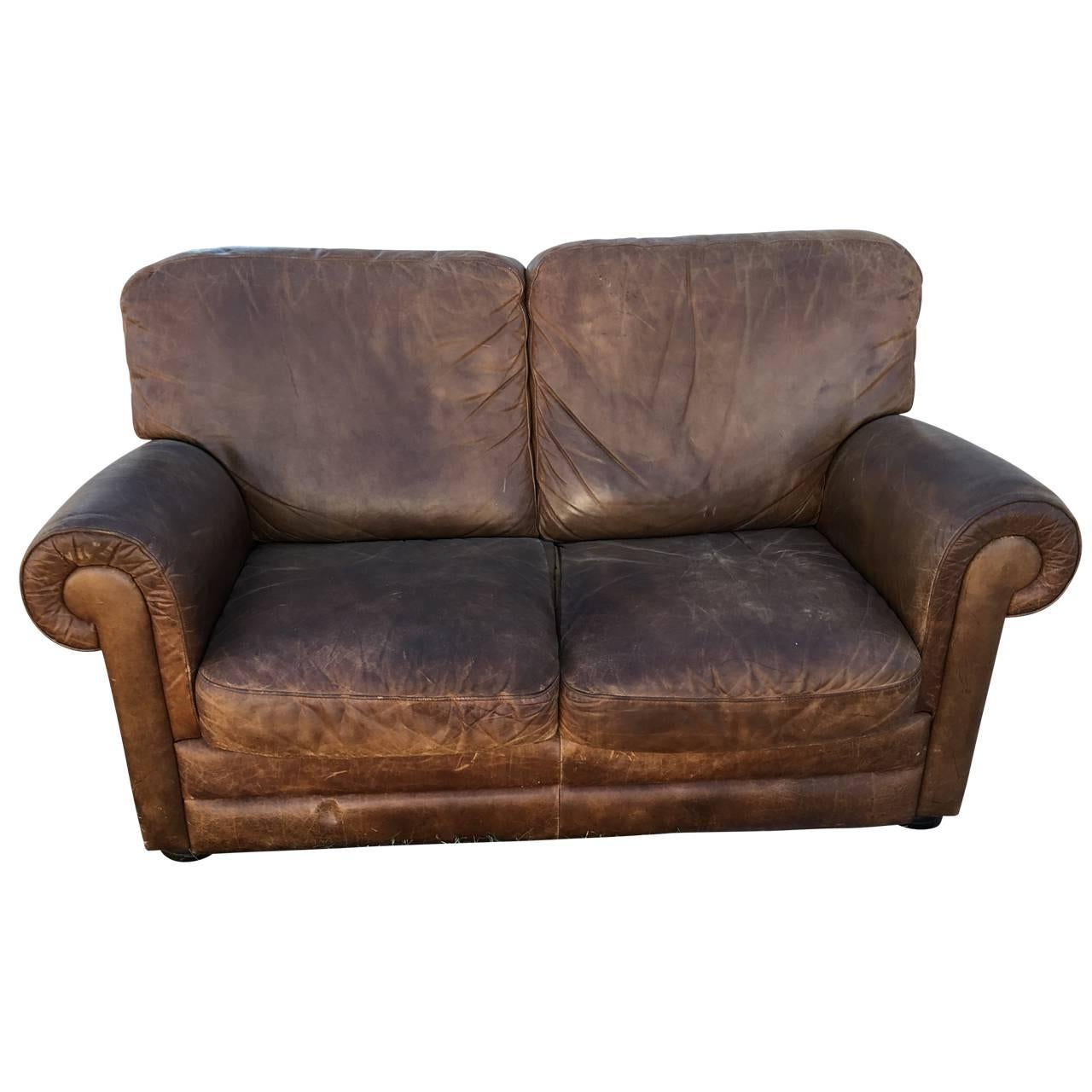 Two seating club sofa in thick cognac leather, on four wood feet.
Mark with made in Italy label underneath.

$190 flat rate front door delivery includes Washington DC metro, Baltimore and Philadelphia