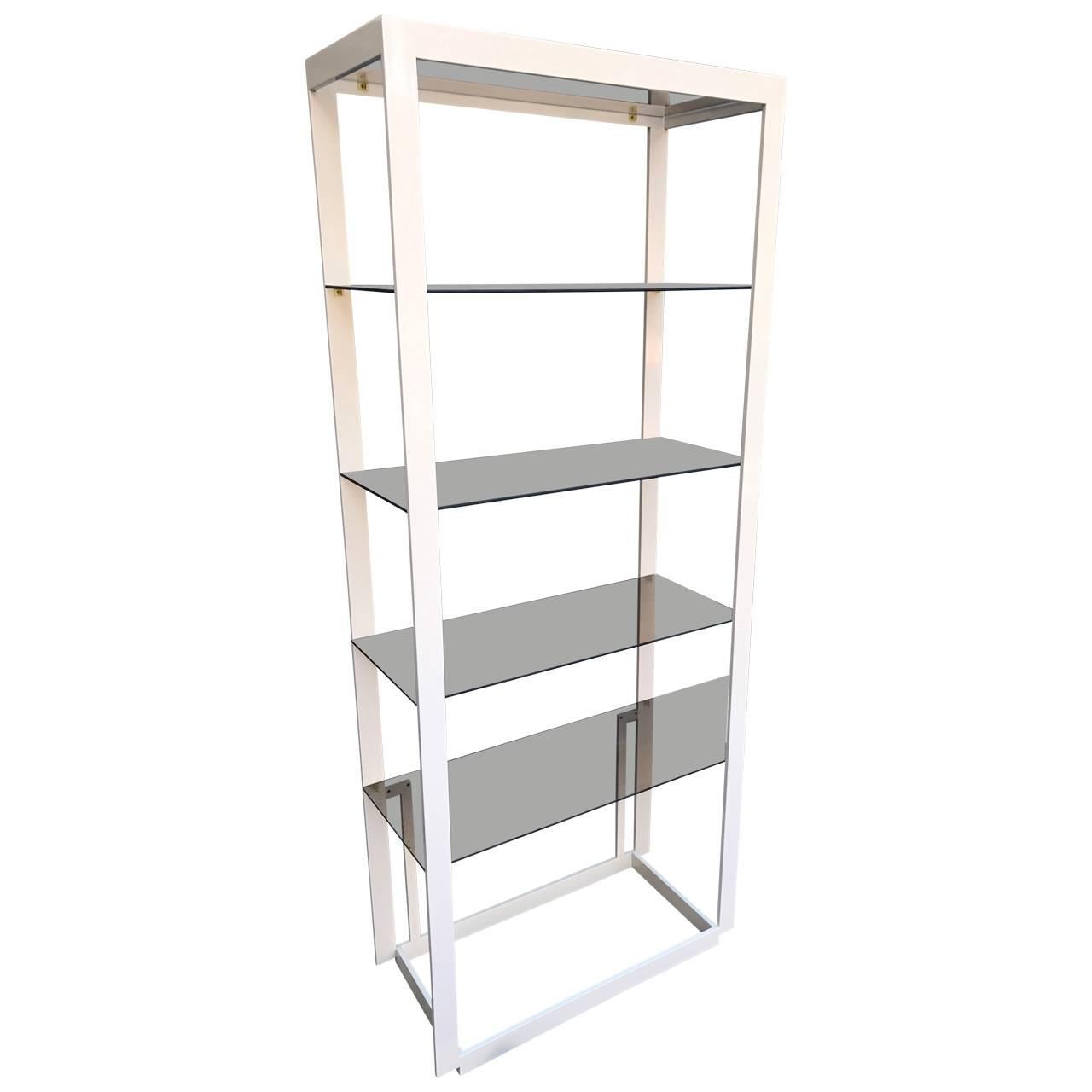 Mid-Century Modern brass etagere shelving fixture painted white.
Tall and sturdy this shelving unit is as functional as it is bright and cheerful. Perfect for an office, kitchen or library, the etagere will display collectibles and books in modern