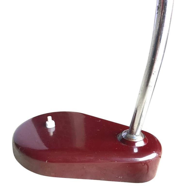 Italian Mid-Century Modern red desk lamp.
This fun Bauhaus style desk lamp has the classic flying saucer shade. It's a wonderful addition to a desk. The oxblood red painted metal has vintage patina. It has also been newly re-wired to US UL standard.