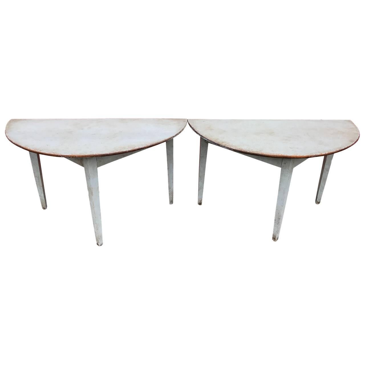 Pair of 19th Century Swedish painted demil-lune tables. This pair of Swedish demi-lune tables are beautiful and quite unusual. The subtle milky grayish white color will be a perfect addition to any eclectic decor. The tables are sturdy yet graceful
