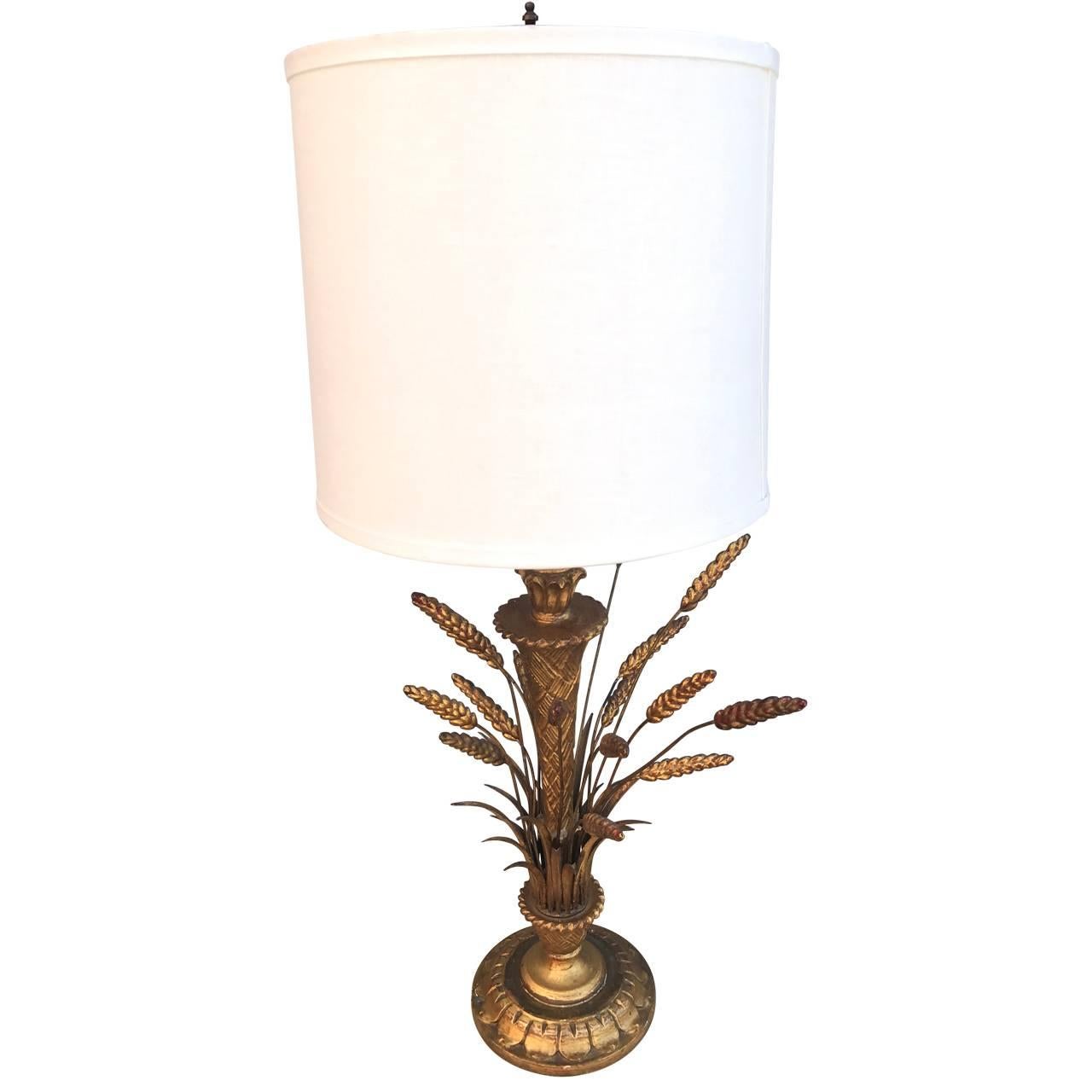 A Hollywood Regency table lamp. In the style of  Frederick Cooper metal and wood sheaf-of-wheat table lamps. This lamp retains the lovely gold trim on the top and bottom in fantastic vintage condition. Wiring is updated and with the perfect shade