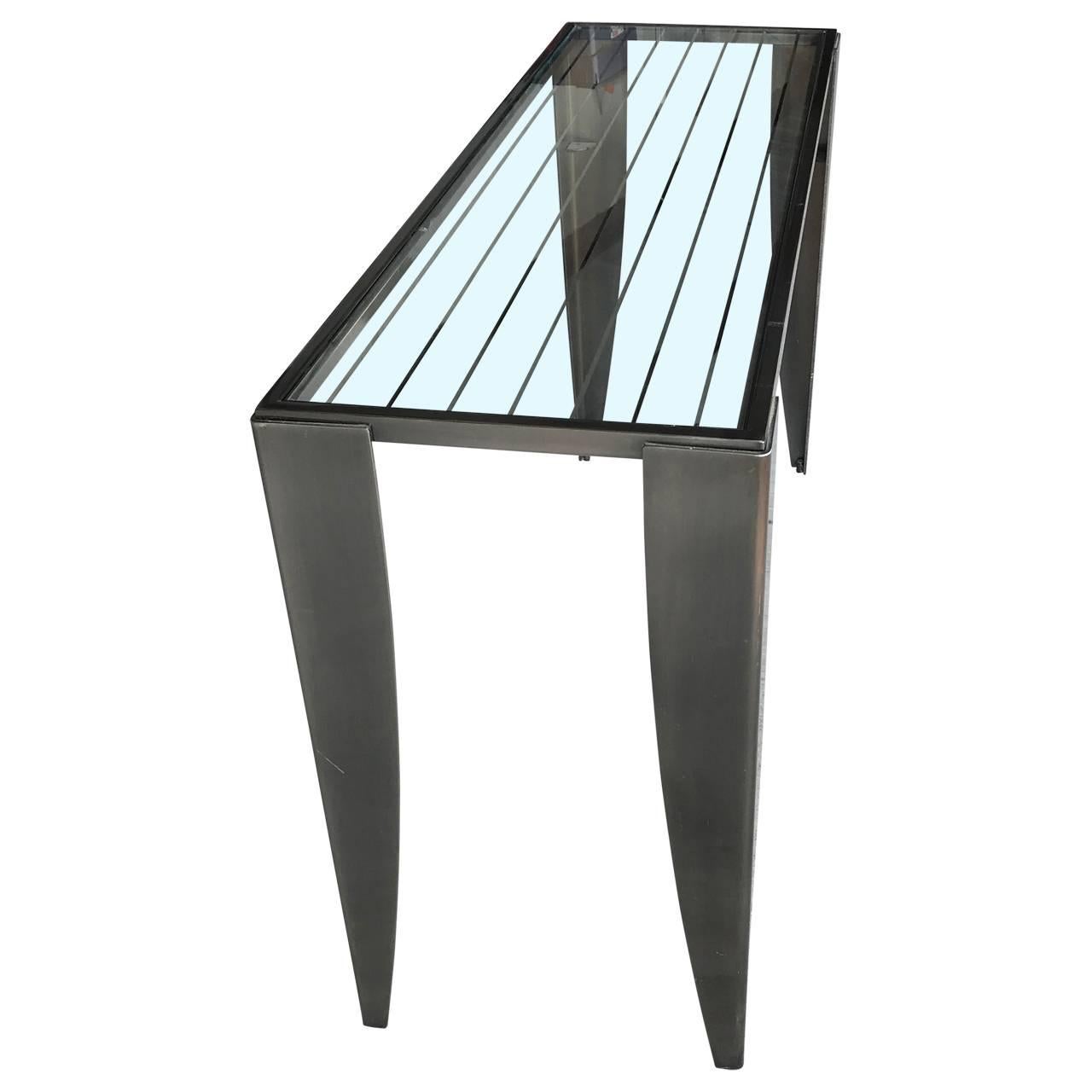 Sleek console table in brushed steel and glass top. Glass top has several etched silvered lines. There is the option of having second glass shelf installed, see detailed image 5 and 6.