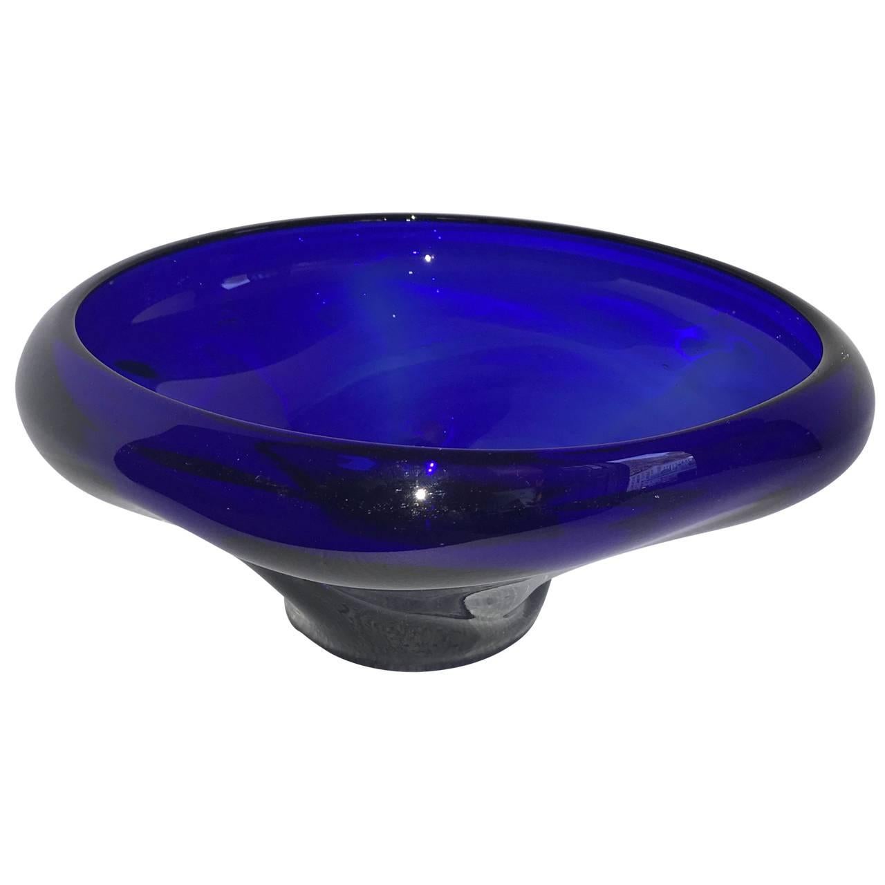 Centerpiece of glass in deep cobalt blue bowl, organic in form and shape. Bowl rests on a cobalt blue base, potentially not original to the top, see detailed images.
Great wear to bottom of bowl.