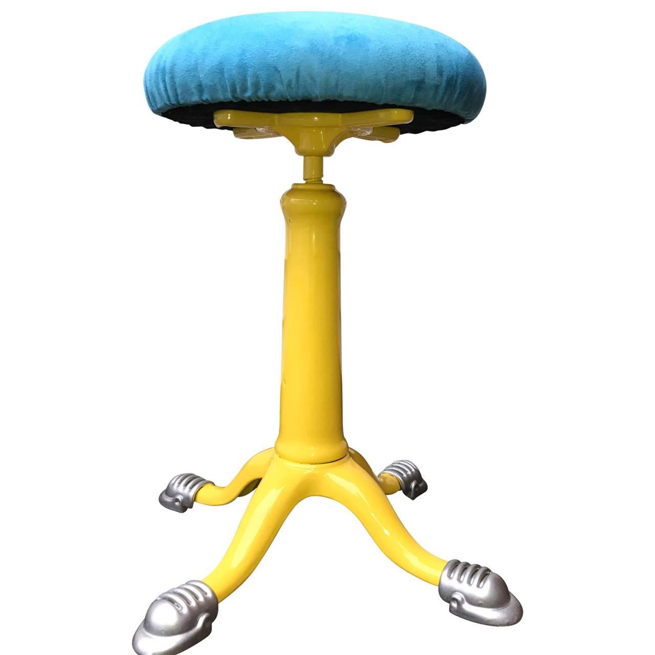 Industrial stool with faux blue suede seat. This fun stool from 1873 has been newly upholstered and powder coated sunshine yellow. Bright and bold, this is a terrific addition to your home. Made in New York, the seat is adjustable for height. 