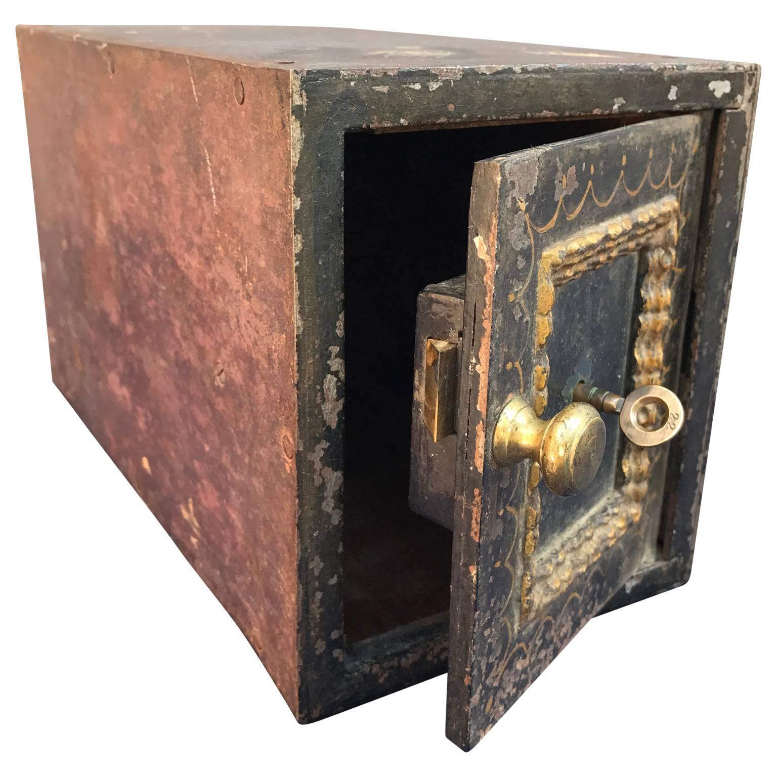 Small 19th century antique steel safe with original key and patina, possibly from an old hotel or club.