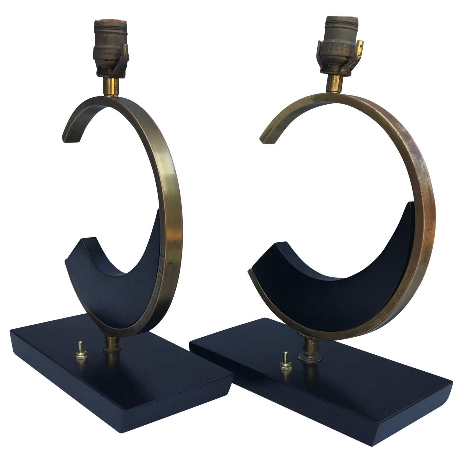 A small pair of bedside table lamps, in the shape of a large C. They have the scent of chanel-look-alike.
The lamps are made of black-paiinted wood and brass with great patina.
Newly re-wired and new brass switch to UL standard.