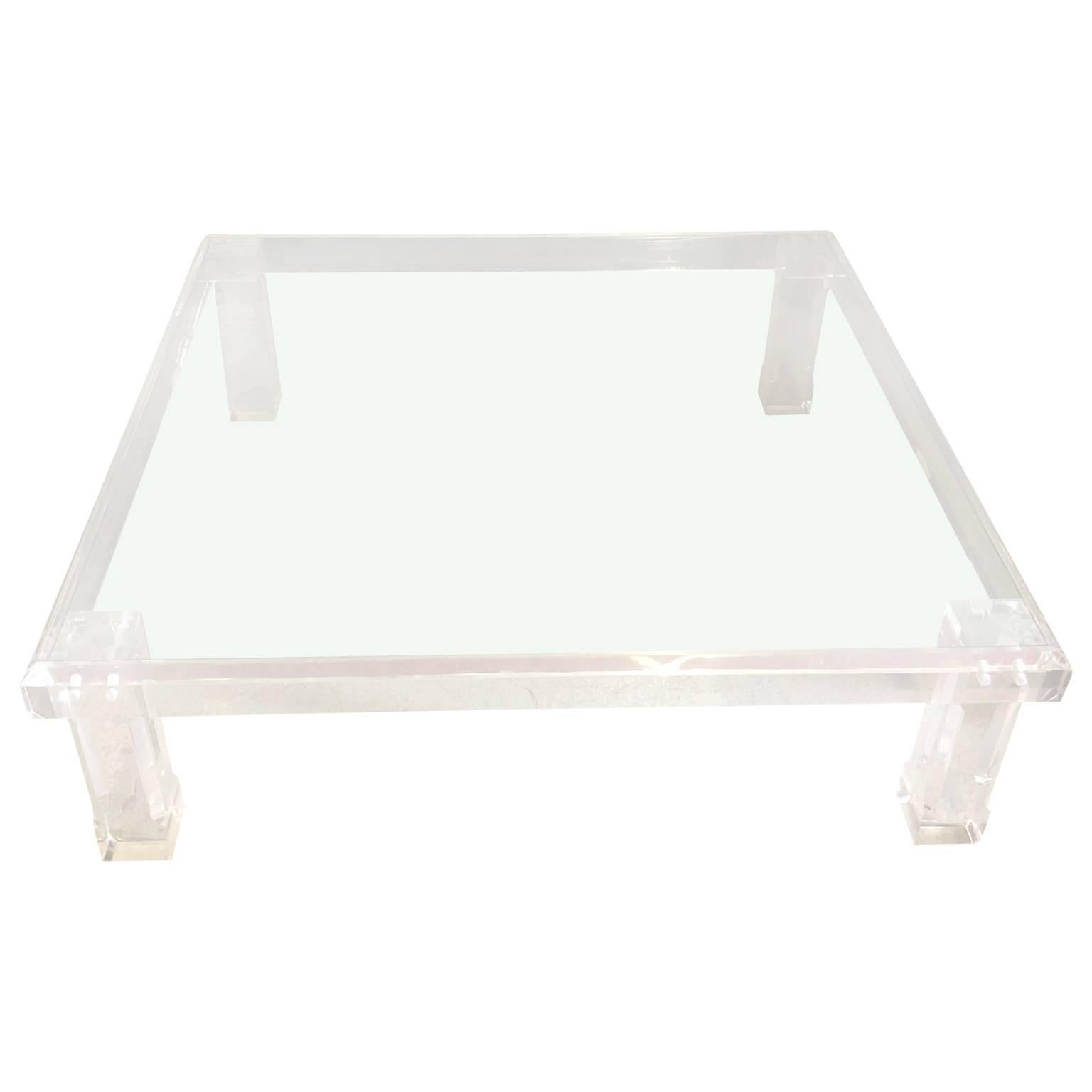 Large lucite cocktail and coffee table with a square 1/4 inch glass top. The outstanding lucite table is oversized and perfect for a large seating modern area. The sturdy, thick legs proudly hold a substantial glass top.