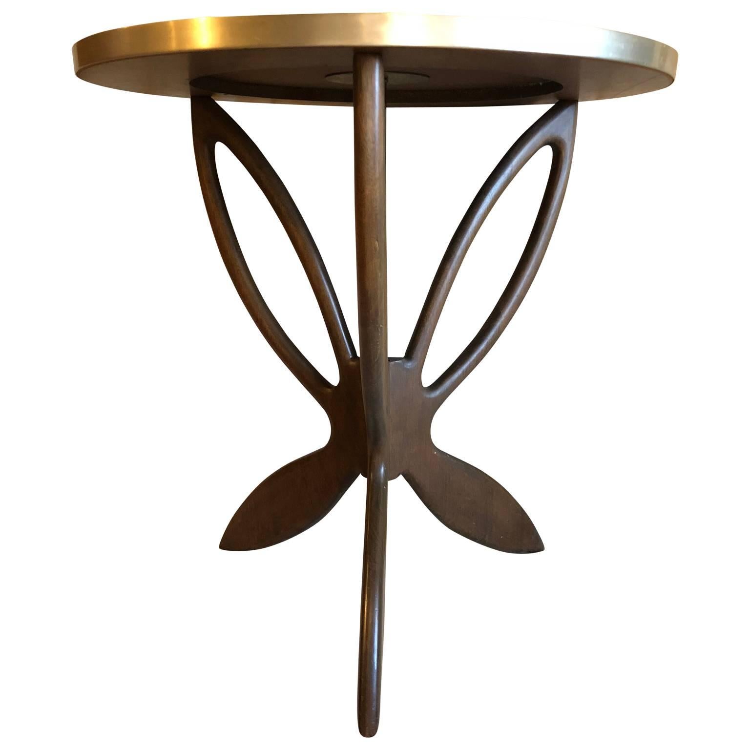 Round modern tile top cocktail table with wooden butterfly legs.
