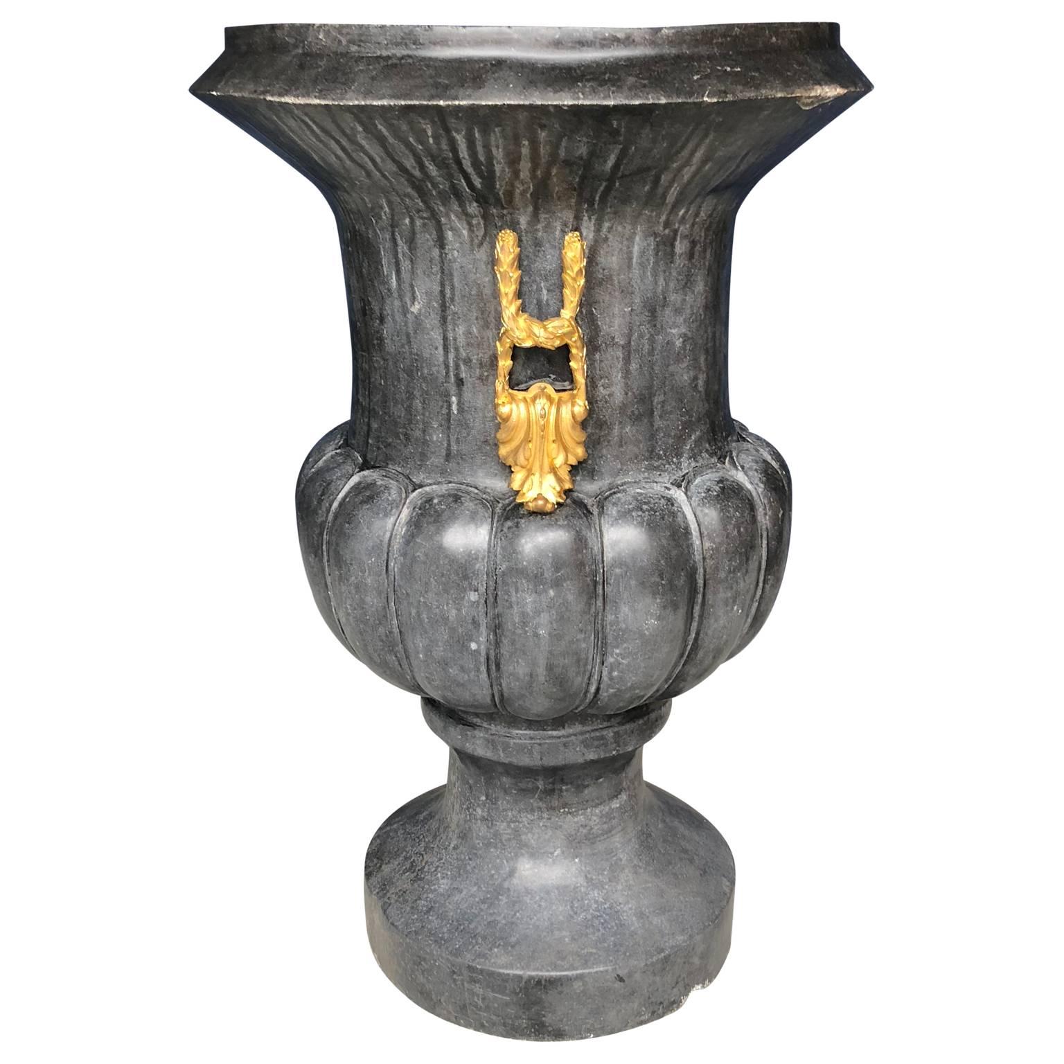 Large Italian hand carved marble urn. The main body is carved in thick wide bulbous marble, a marble that has a variety of black charcoal shades, see detailed images.
The urn is decorated with two large high quality 19th century ormolu gilded