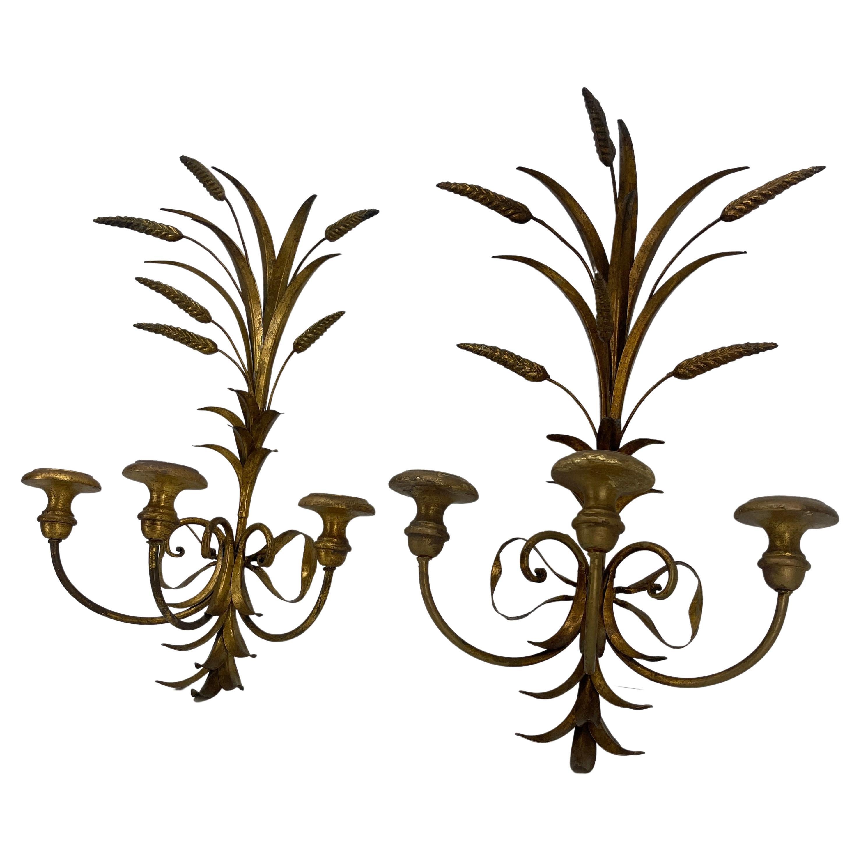 Hollywood Regency gilt wheat sheaf pair of candle sconces in the manner of Salvadori.
This glamorous pair of wall candle sconces is an iconic style to the period of beauty and elegance. The sconces will be perfect gracing a dining room, hallway,