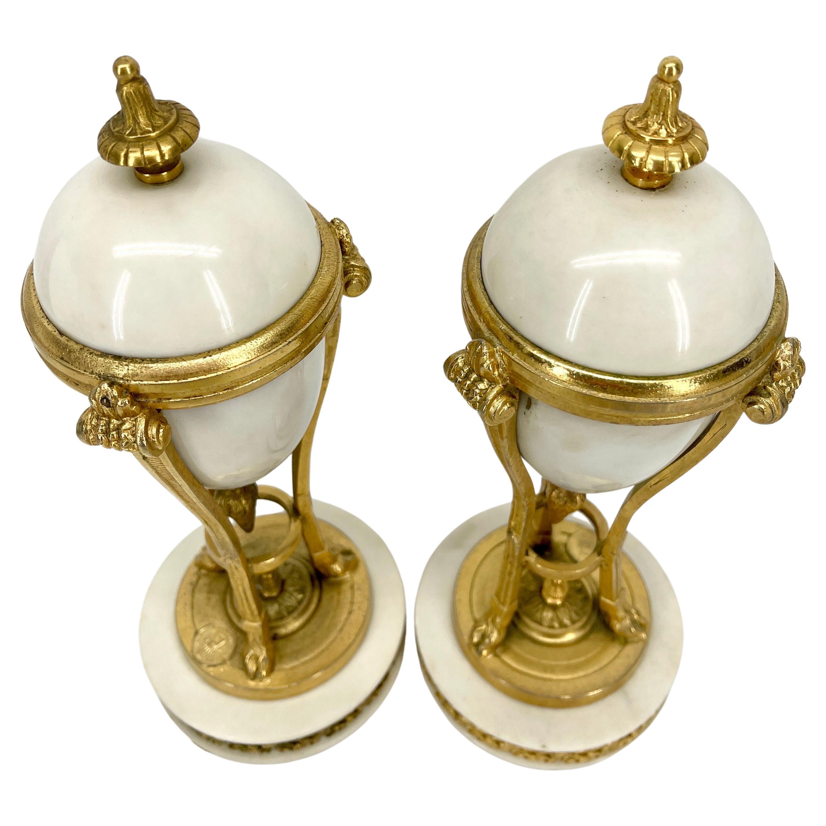 Pair of French Louis XVI style gilt bronze-mounted white marble urns

This pair looks like cassolettes, however the are just urns.

 