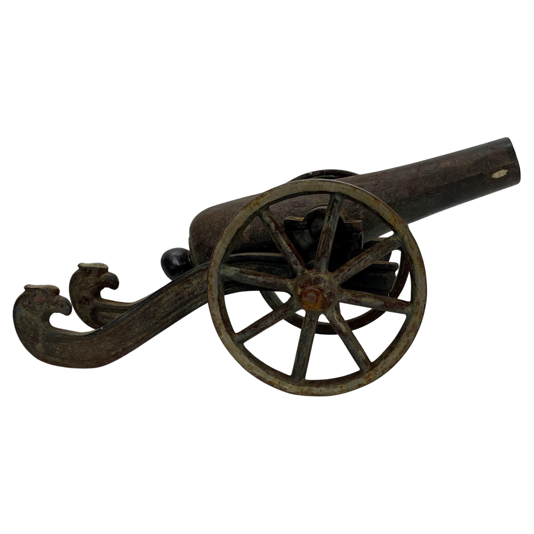 Cast Small Early 20th Century Iron Cannon Desk Accessory with Eagle-Head Decoration For Sale
