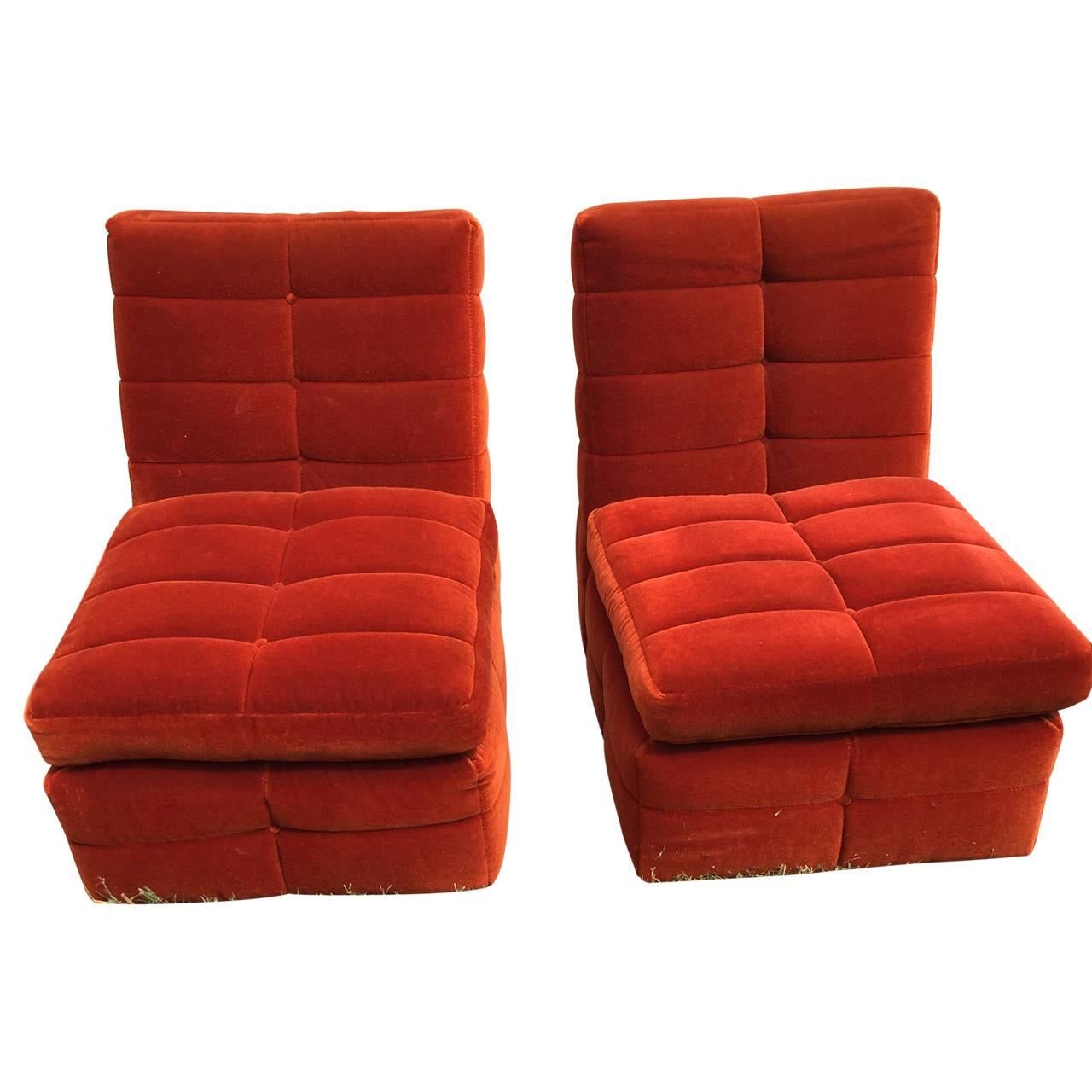 Pair of orange Milo Baughman lounge chairs.