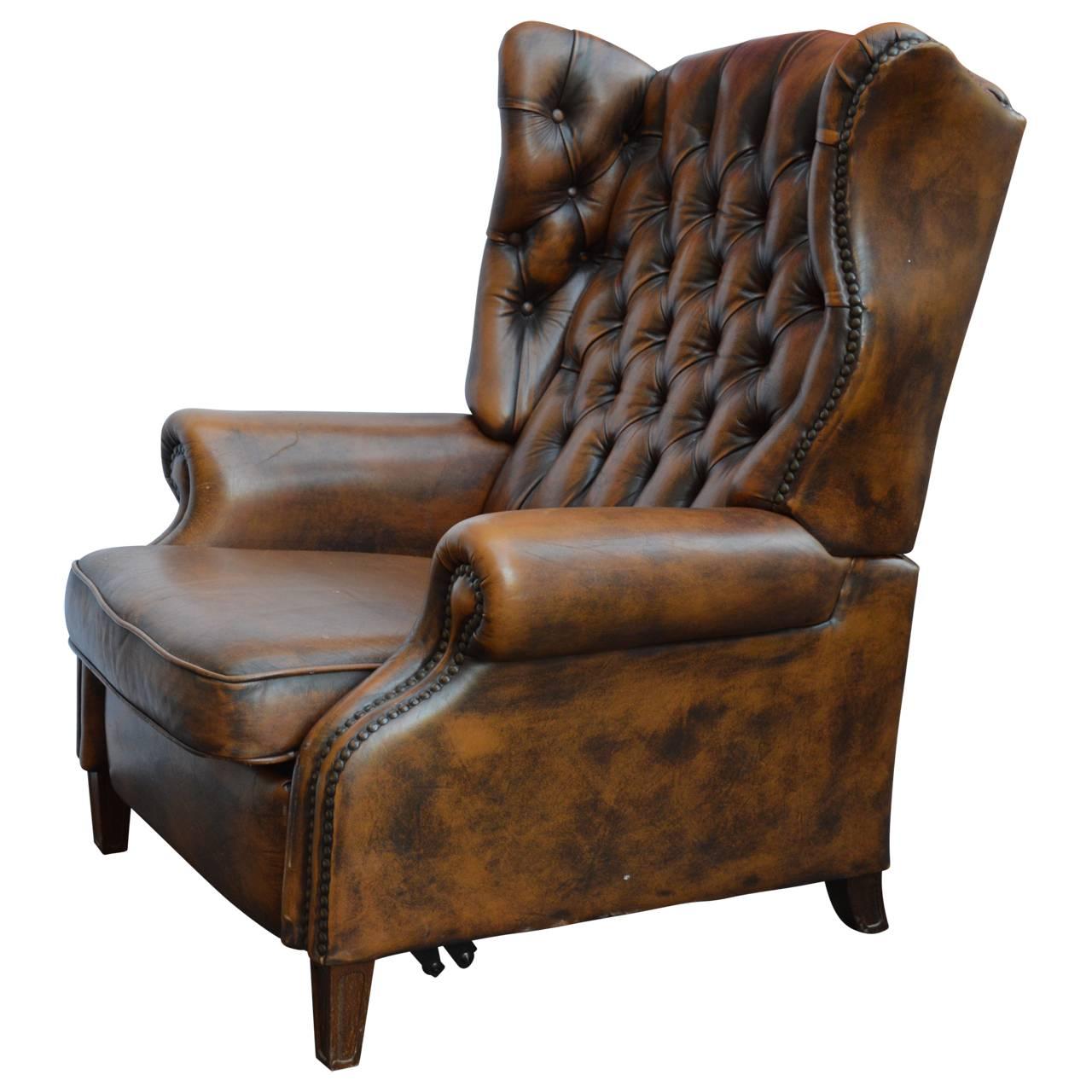 Large Chesterfield armchair with internal footstool.