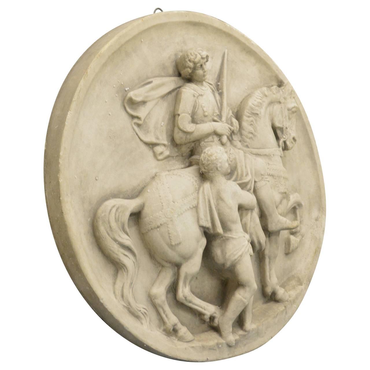 Large equestrian French wall plaque. 
This scene is a popular one in Christian art.  It is St. Martin of Tours, who was riding on horseback when he encountered an almost naked beggar in Amiens.  He cut his own cloak in half with his sword to give