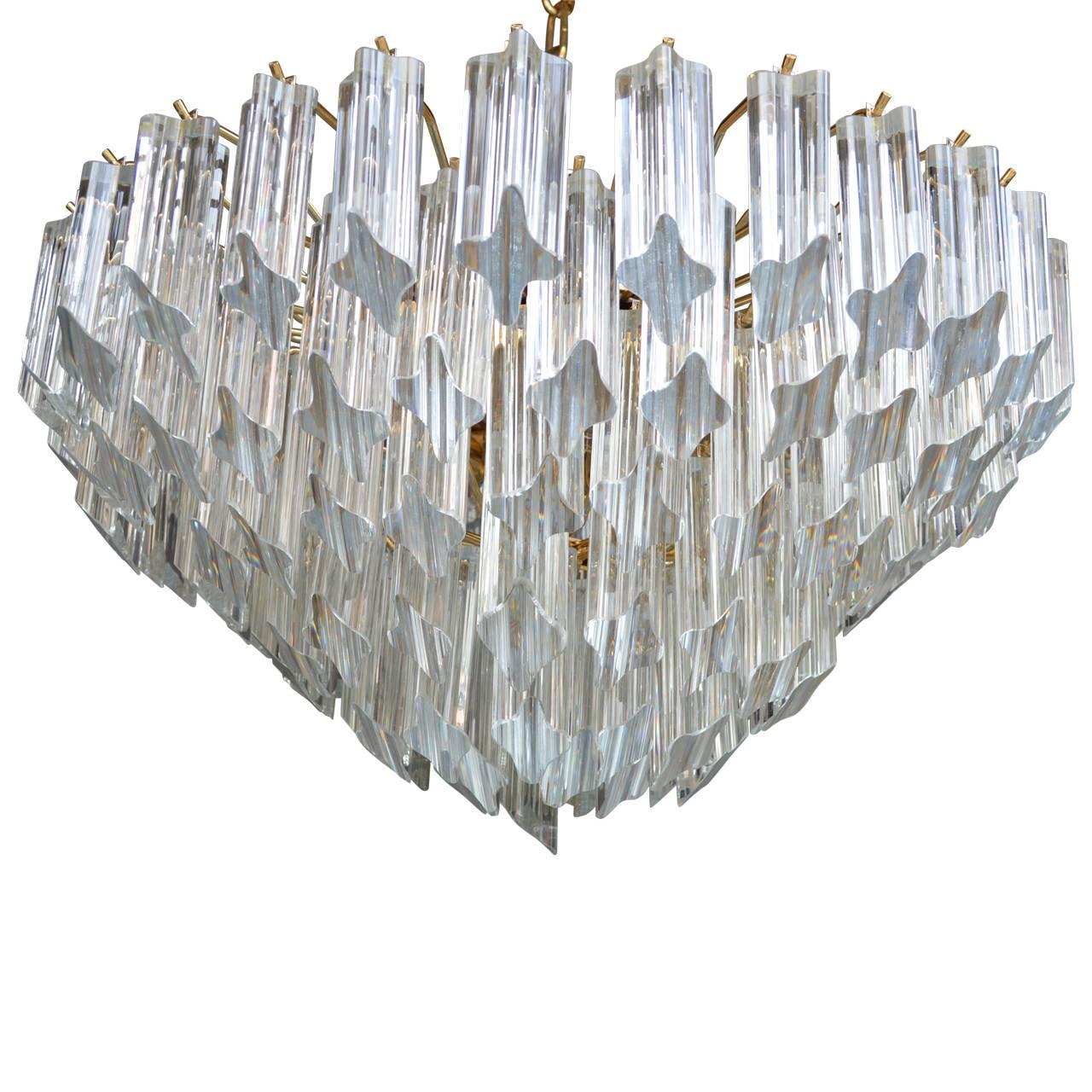 Stunning Venini multi-tiered prisms chandelier. Featuring six-tier Quatro Punta angle cut crystals. The frame is a brass plated steel with a 24