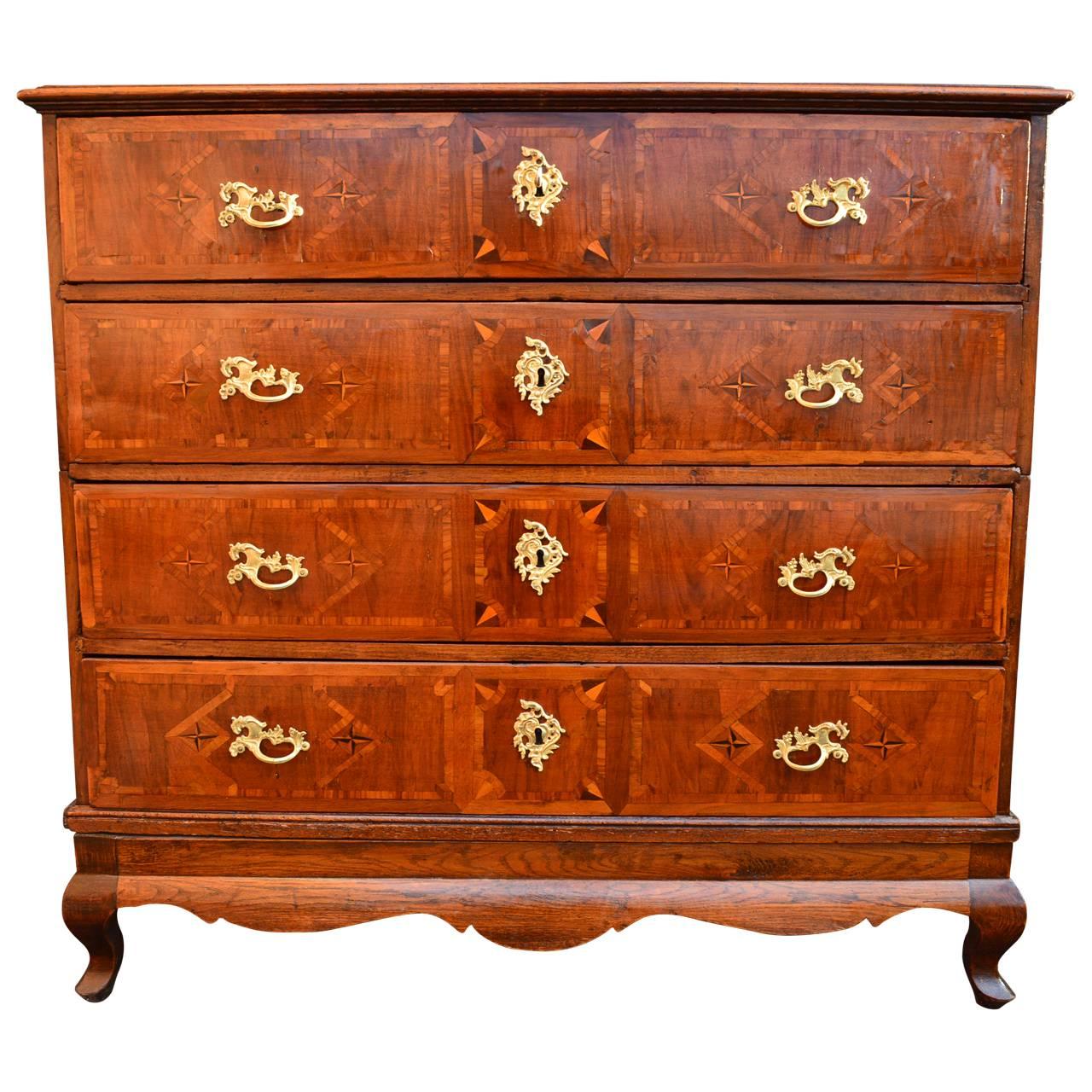 Danish Baroque dresser with four drawers, period brass hardware and key. Inlaid fruitwood decorations, sharp intarsia work.