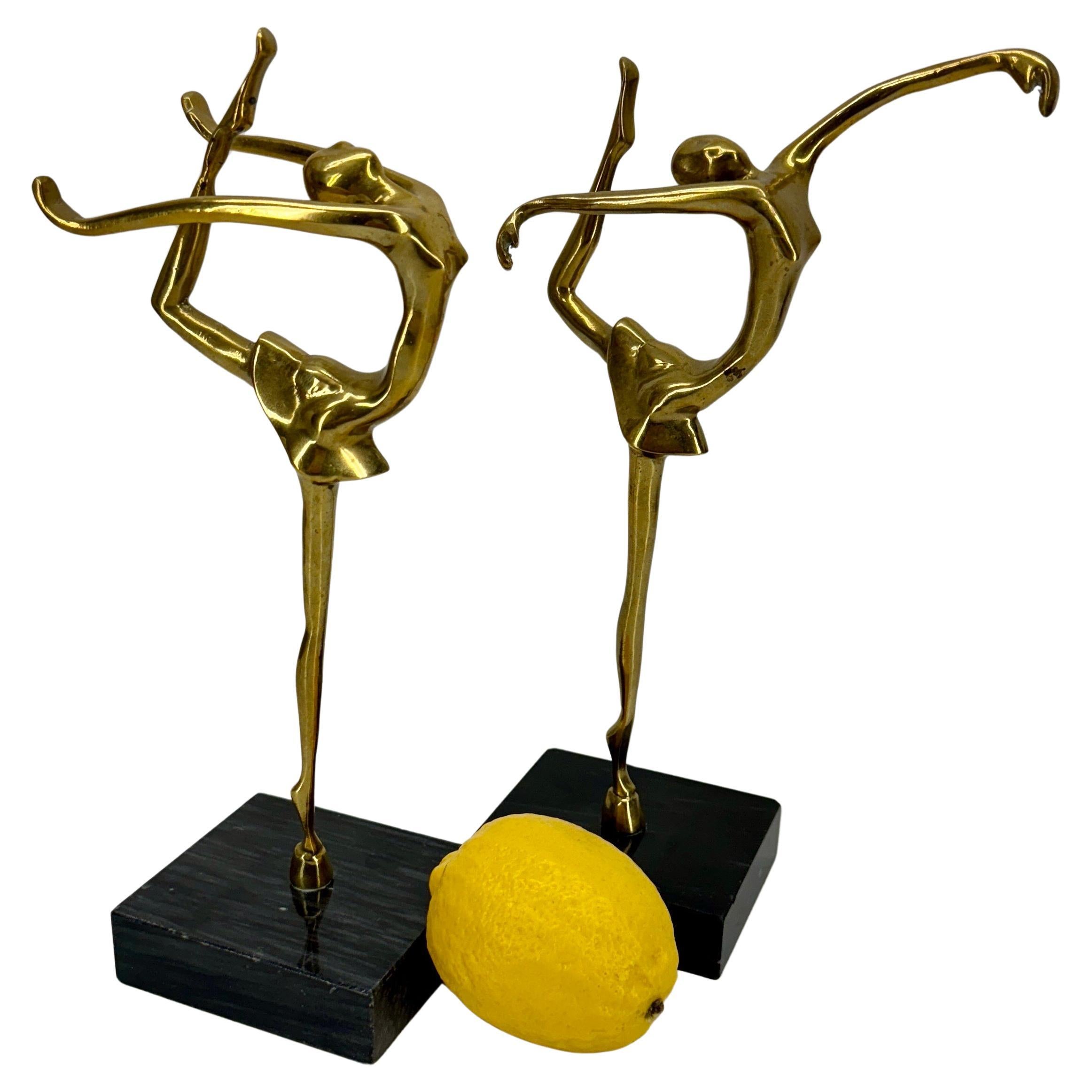 Brass Women Figures Dancing, A Pair, Circa 1960's

Charming pair of dancing ballarinas set on top of marble bases. Certainly makes a gorgeous statement in an open bookcase or decorative objects set on a table around the home or office. Wonderful set