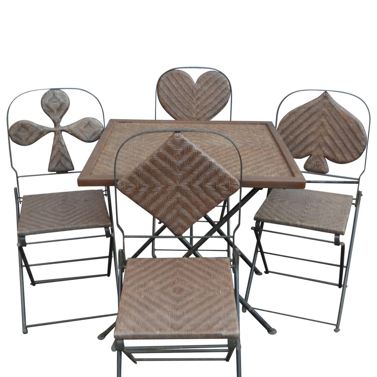 Four French suits metal wicker chairs and table; clubs, diamonds, hearts and spades.