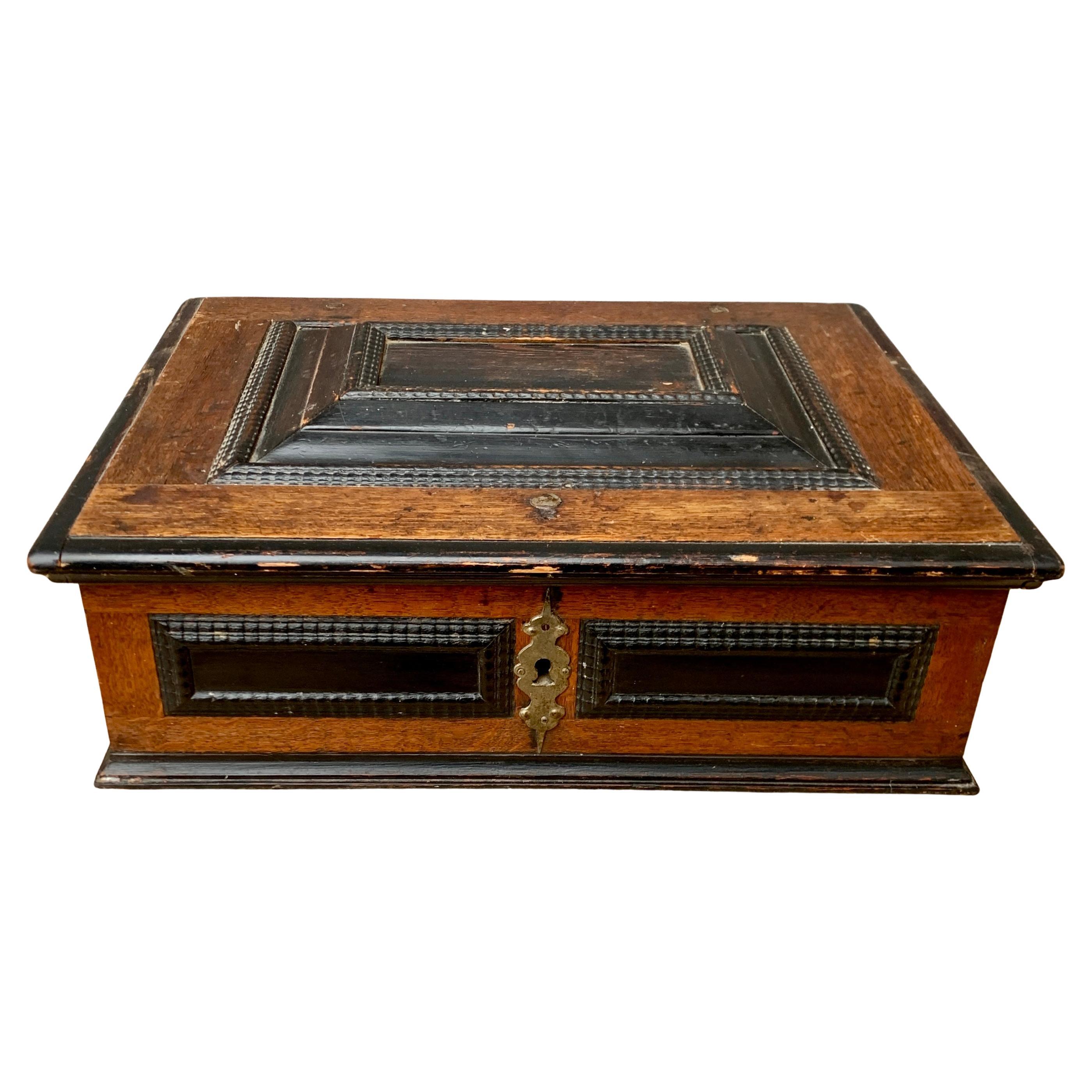 A Scandinavian Baroque oak wood box with original ironwork, partially black painted.  
We acquired this piece in the region of 