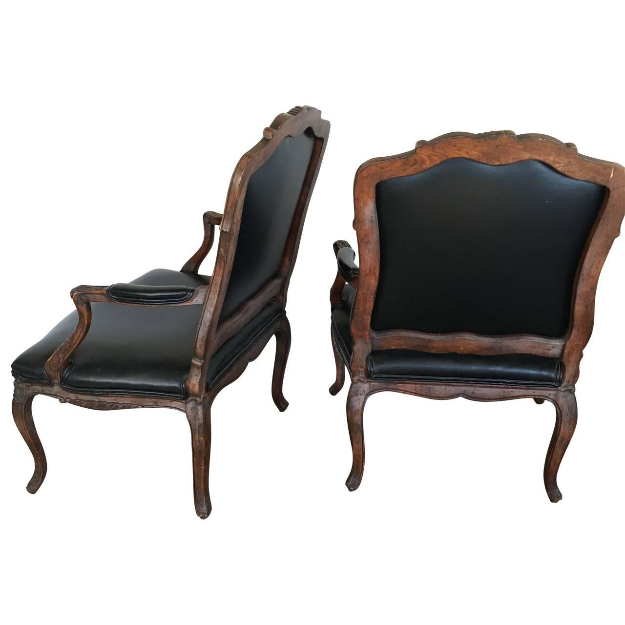 Newly upholstered pair of French Rococo armchairs.