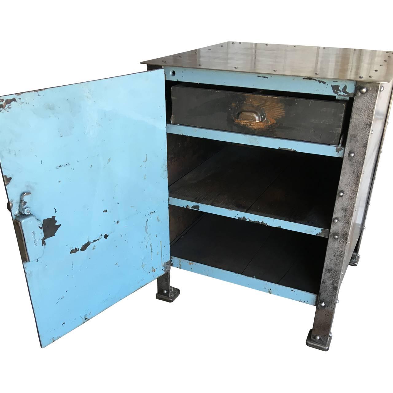Industrial Metal Cabinet, circa early 1900's.
American made, hand riveted locking cabinet from a textile factory in Reading PA. The cabinet was used for the textile workers to secure their sheers and tools for their workstation. The interior has the