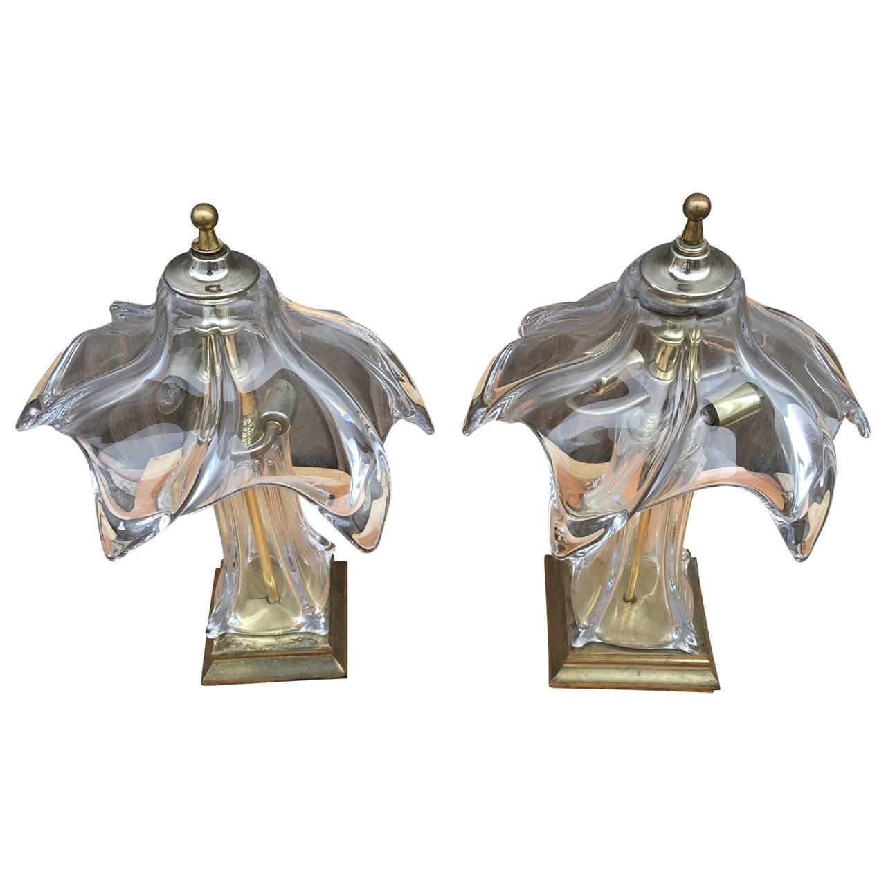 Mid-Century pair of Murano glass lamps.
This pair of lamps are graceful and quite unusual. The shades are handblown Murano glass in a beautiful curved design. The bases are a heavy and sturdy brass with a vintage patina. Lovely as nightstand lamp