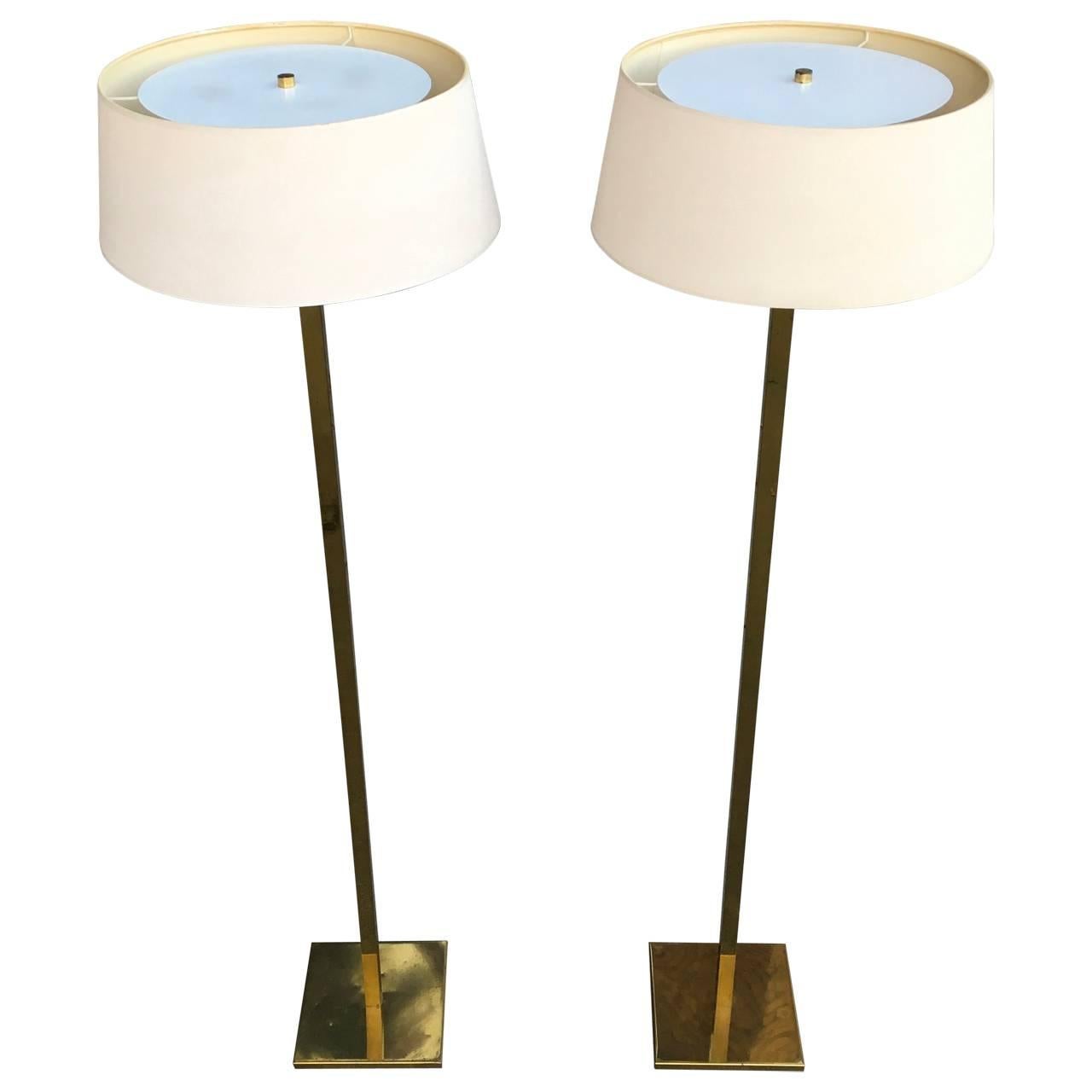 Tall pair of signed Mid-Century brass floor lamps on square base.
The lamps are in the original brass finish and original fuses and hard ware. Can be re-wired to modern code if need be.
Signed Nessen Studio NY, impressed into the socket.
Comes with