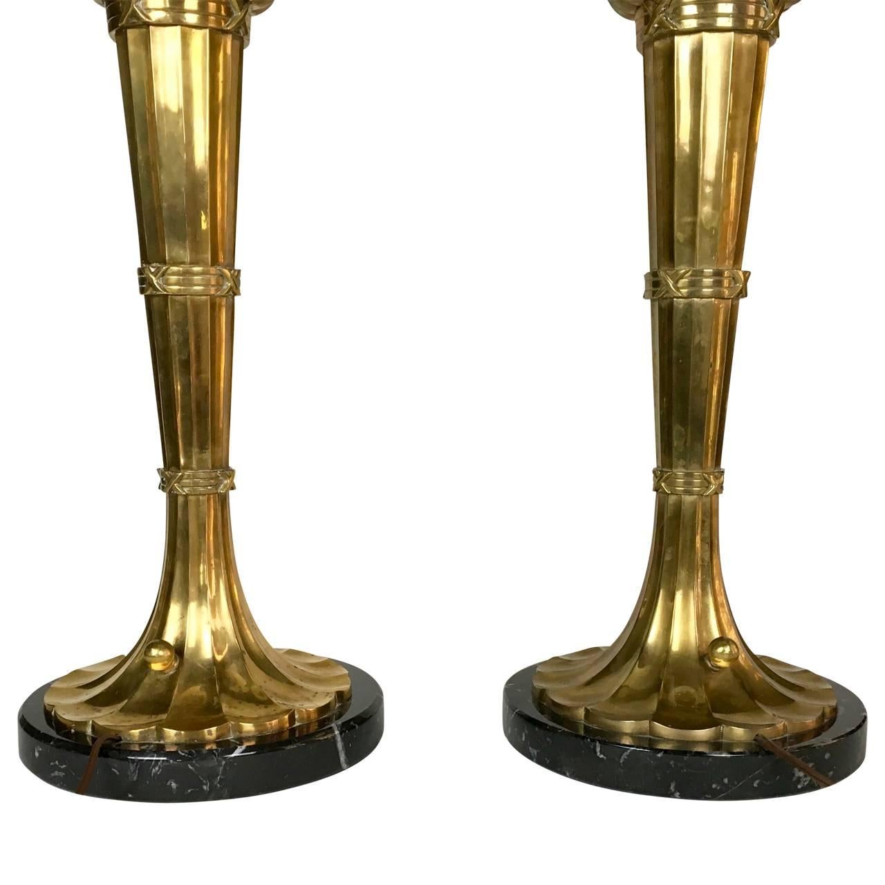 Pair of large brass torchiere table lamp by Chapman.
Substantial in size, stunning solid brass French torch design with heavy frosted glass shades, Italian black marble bases. Extremely well made. Chapman sticker on bottom 1989 Chapman. Perfect