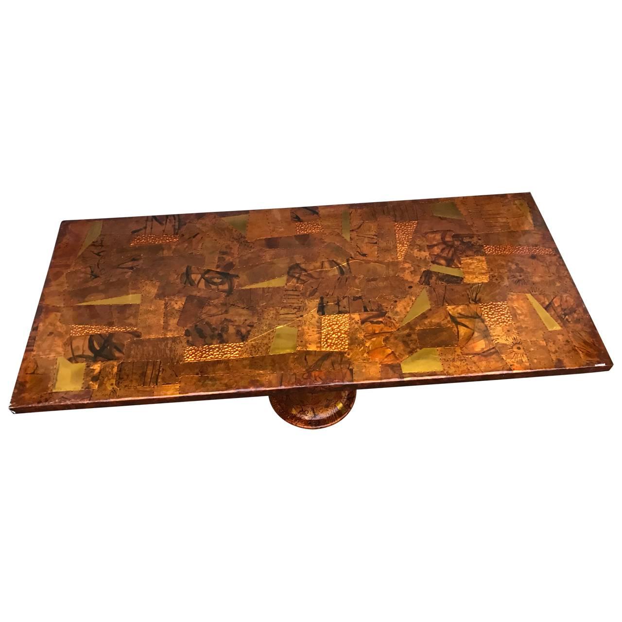 Large patchwork dining table on painted Industrial iron base. Glass top protects the art work.
The tabletop is coated with thick hard lacquer that protect the great looking copper and brass patchwork. 
Glass top is included but not pictured in this