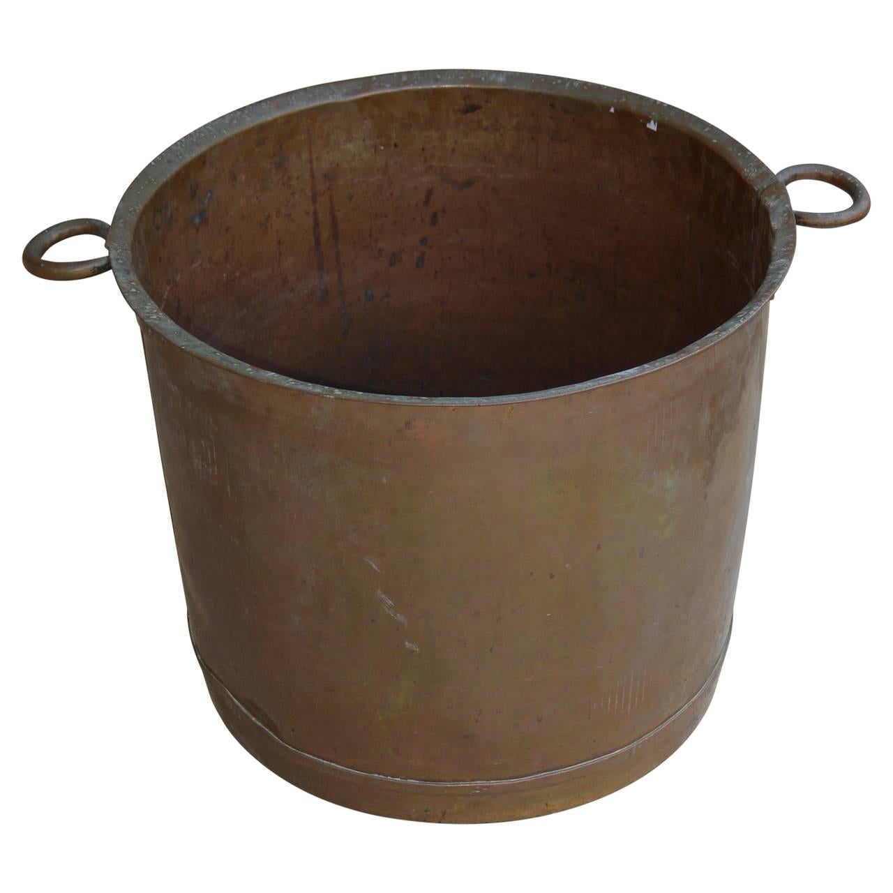 Large two handle copper cauldron, perfect for firewood.