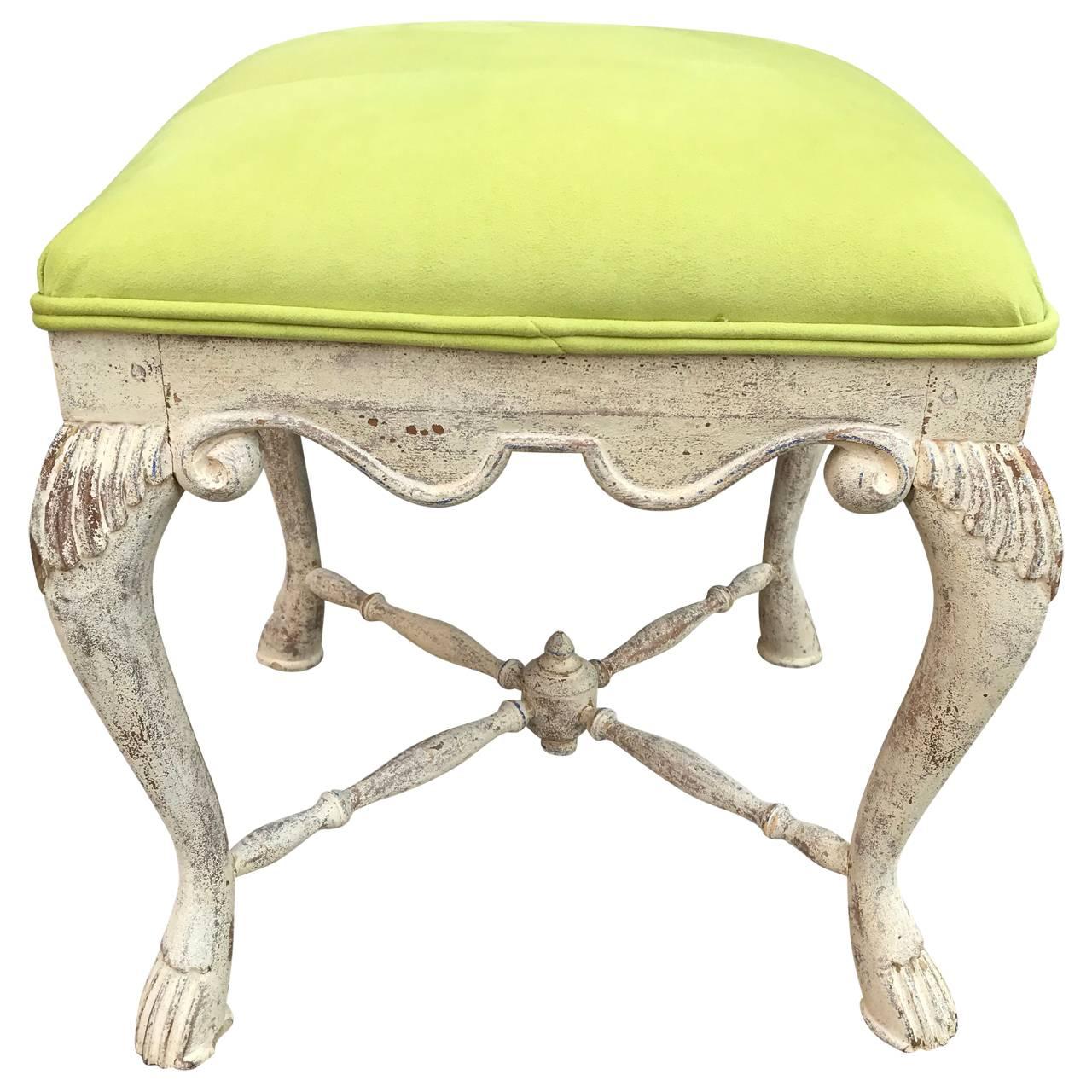 Swedish foot stool, with traces of multiple colors after being scraped down. Stool is newly upholstered in a bright lemon green faux suede fabric 
 