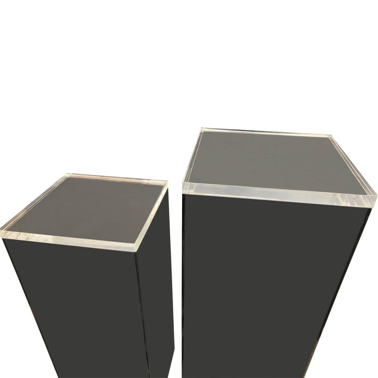 Two Lucite art pedestals both with smoked Lucite base and separate clear Lucite tops.

Pedestals measure 30