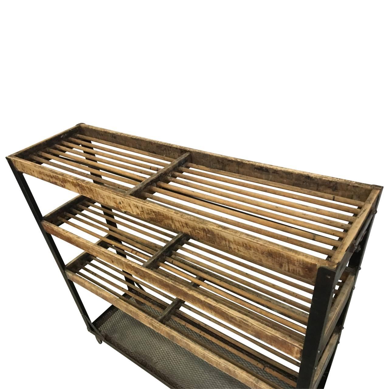 Industrial steel cart with two wooden shelves.