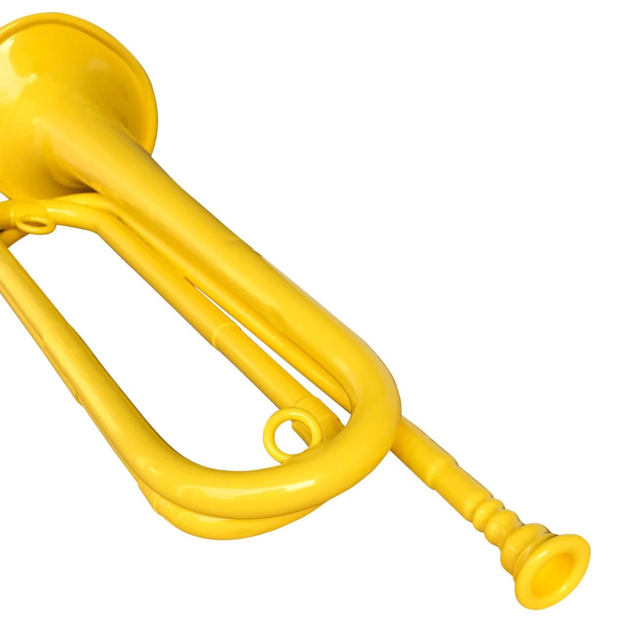 Old brass bugle newly powder coated in bright yellow.