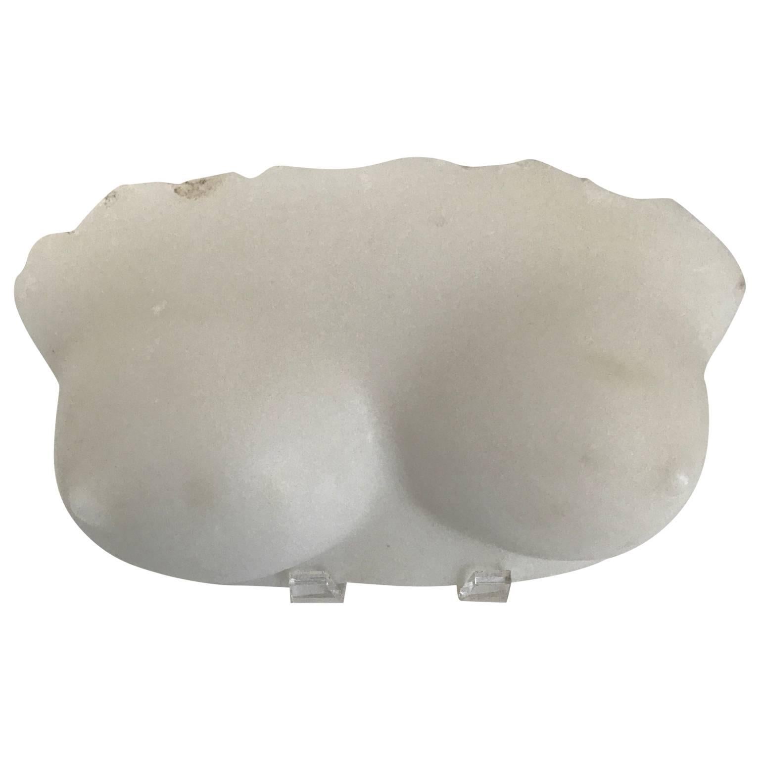 Marble fragment sculpture of bosoms.