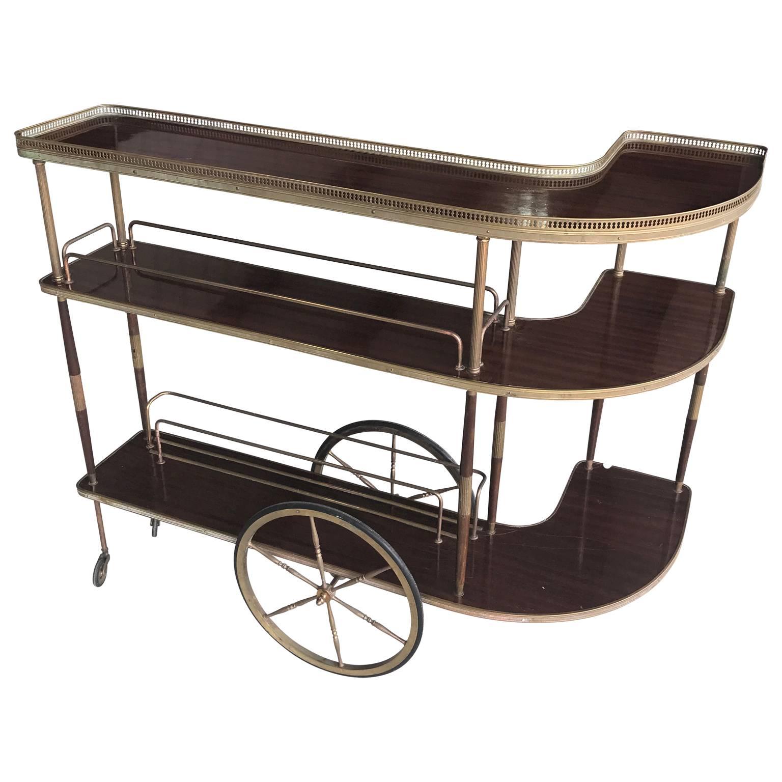 Rare three-tiered neoclassical mahogany and brass drinks trolley.
       