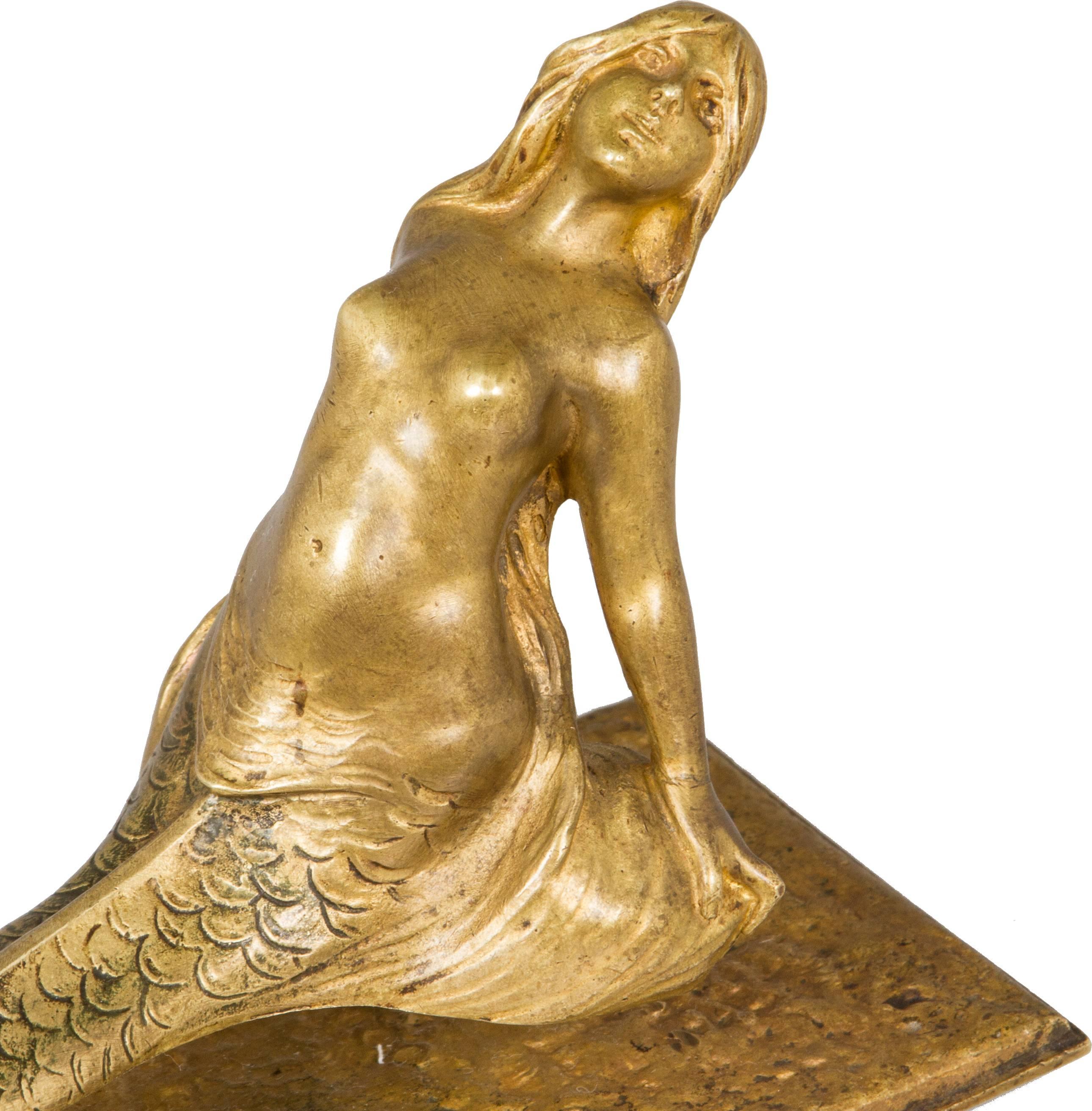 This is a beautifully sculpted bronze doré letter opener. A mermaid sits atop a flower.