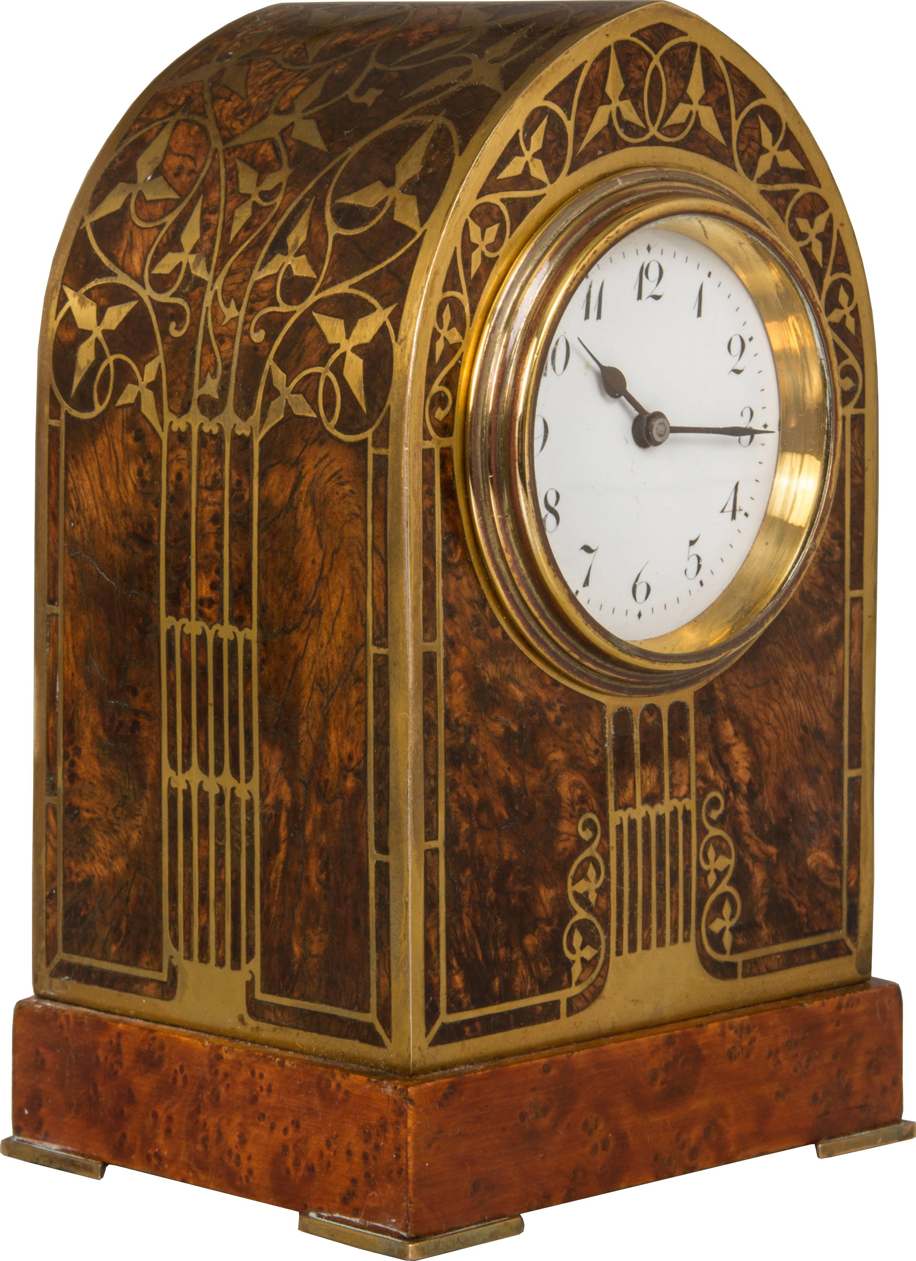 This is a beautiful clock, with inlaid exotic woods and brass.