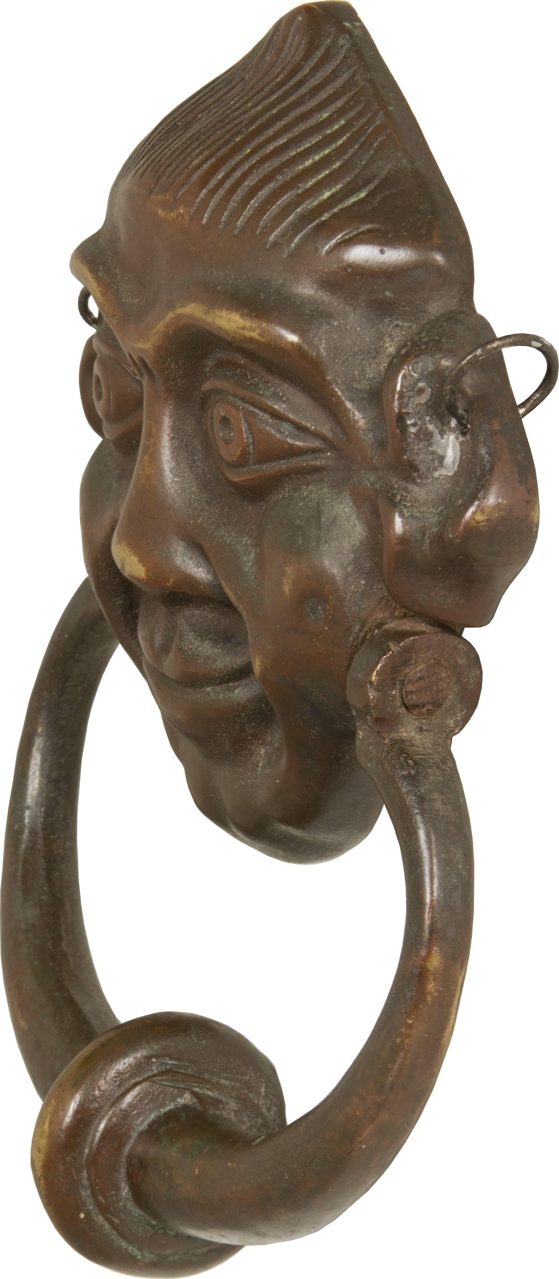 This is a wonderful door knocker with its original patina.