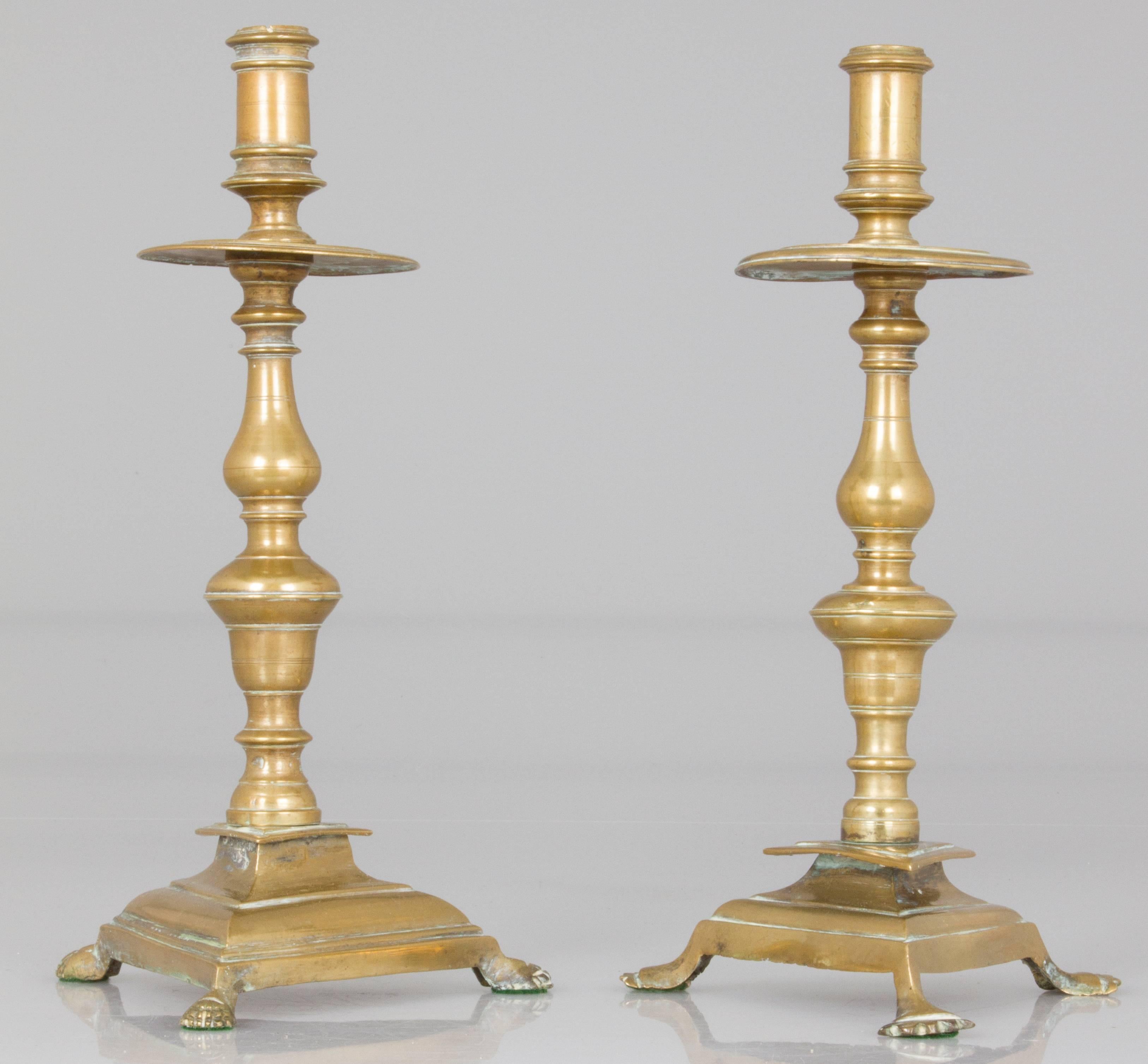 These are two pairs of similar antique English candlesticks.