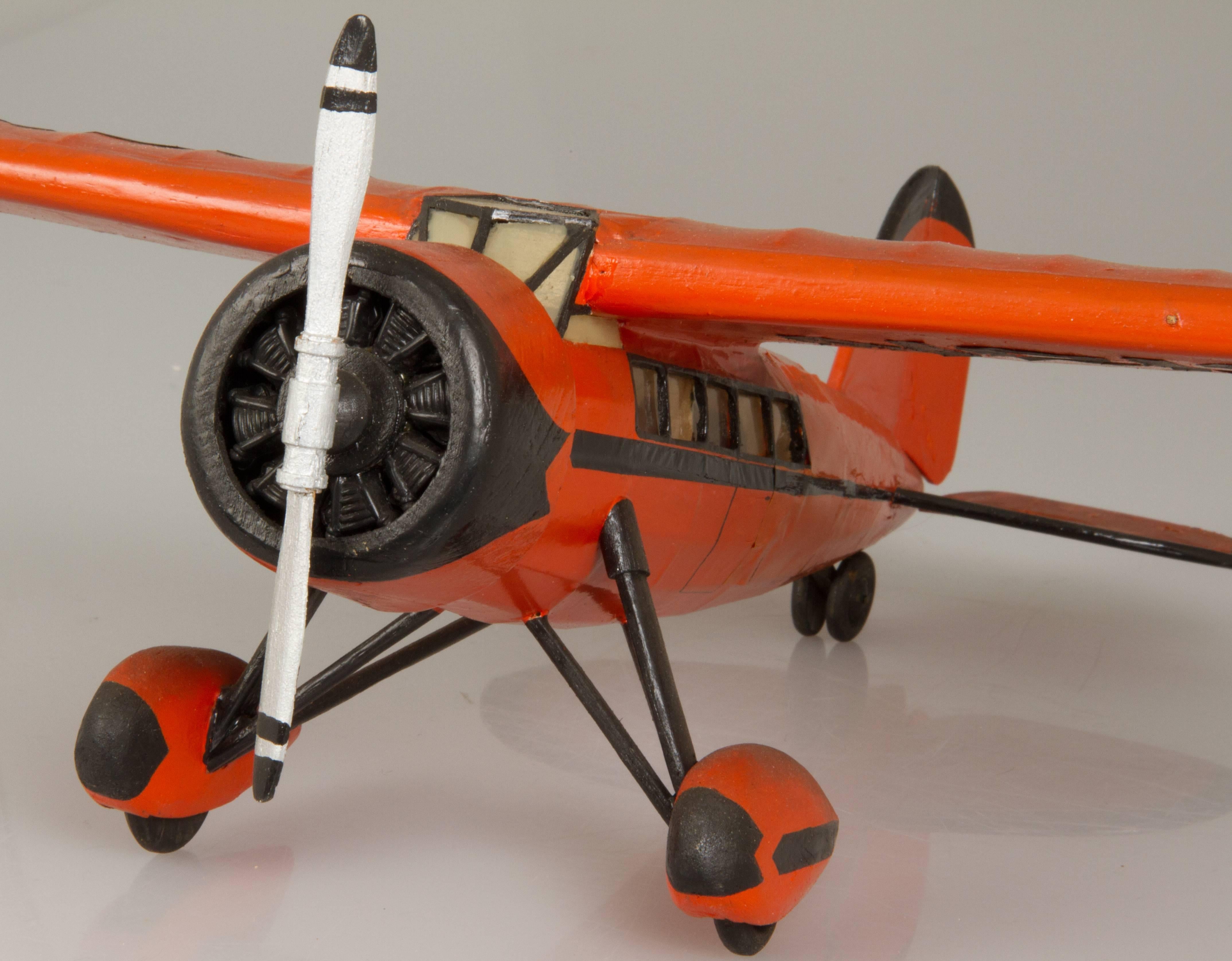 This is a handmade sea plane in a wonderful orange color. The Vega was well-known for being a favorite aircraft of Amelia Earhart. The plane is made of paper over blast wood.