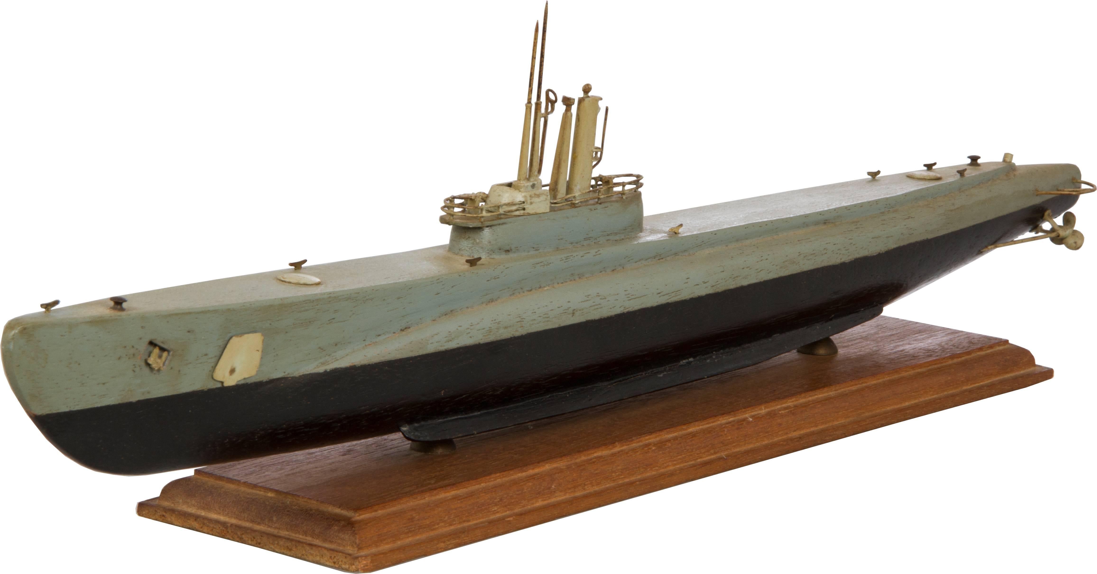 This is a handmade model of a US submarine mounted on its original stand.