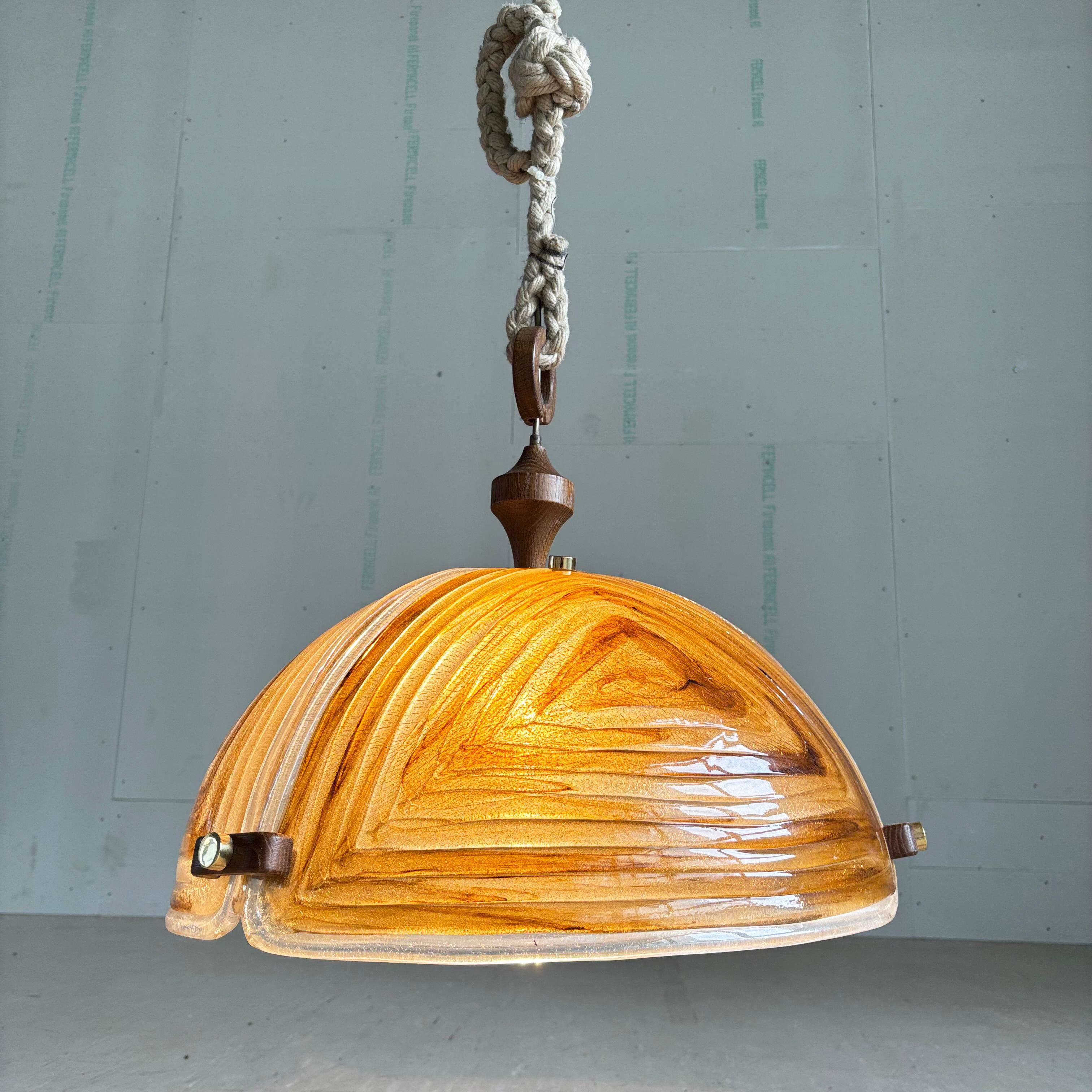 Late 1960’s / Early 1970's Brutalist Pendant Lamp. Perspex shade in warm tones of amber, gold & browns which hang by a thick woven rope to create a wonderful warm, diffused lighting. Beautiful wood and brass accents. 
Attributed to Temde,